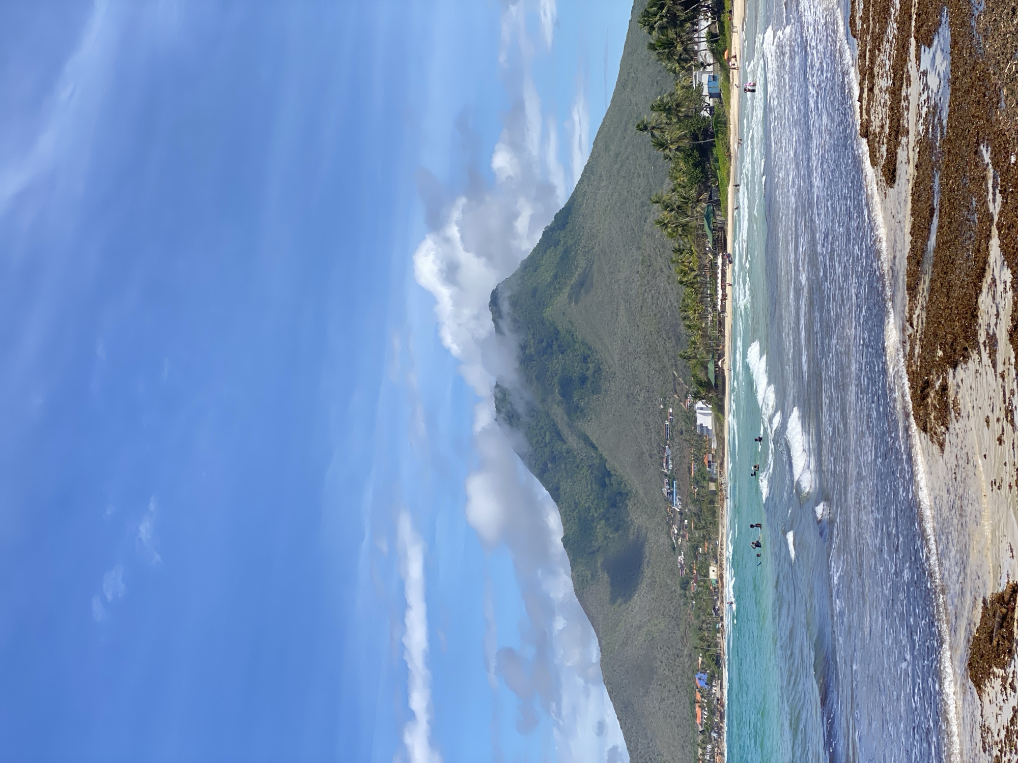 Colorful fishing boats line the shore at El Tirano beach