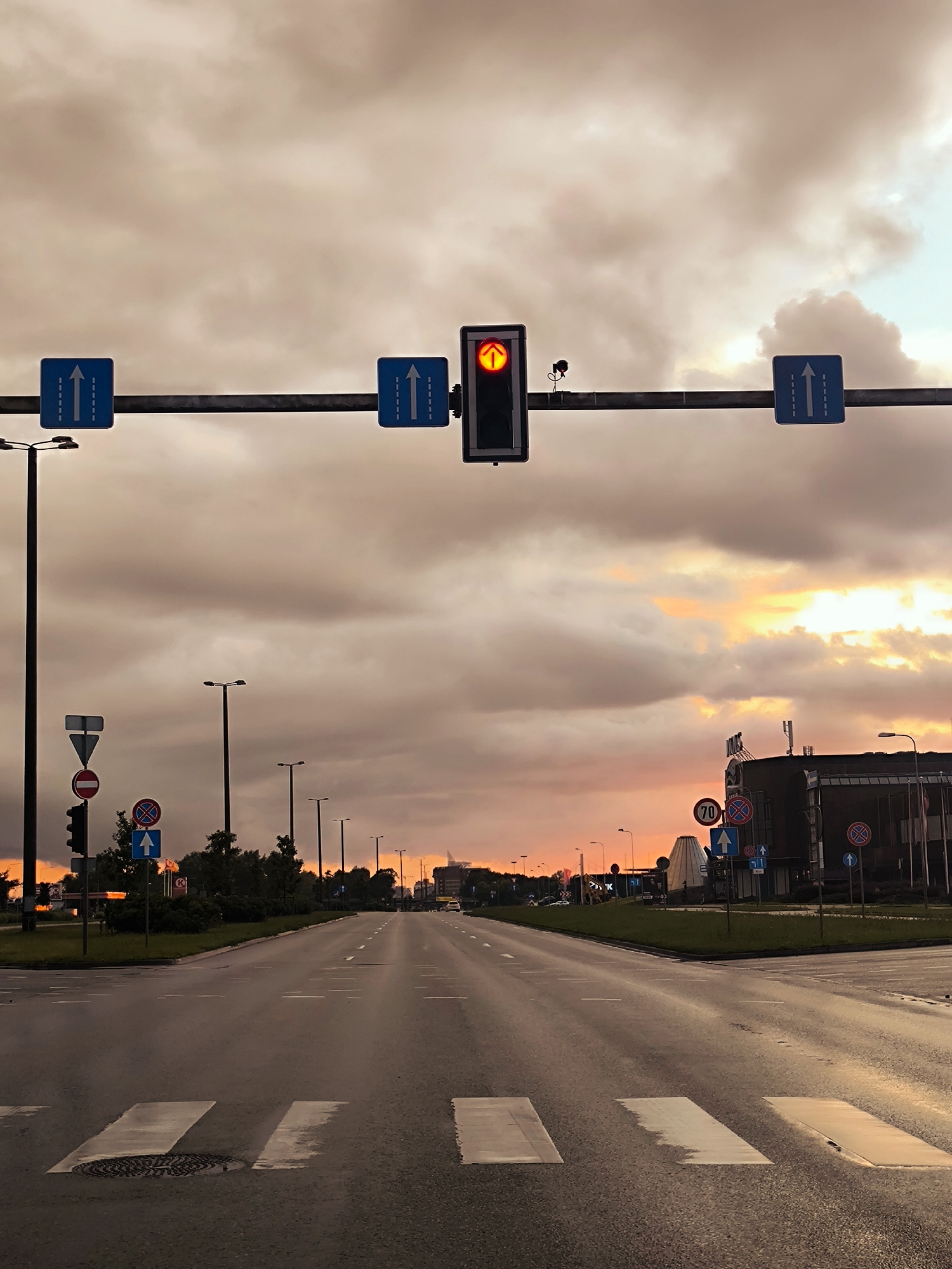 Riga intersection at sunset, red arrow signal glowing