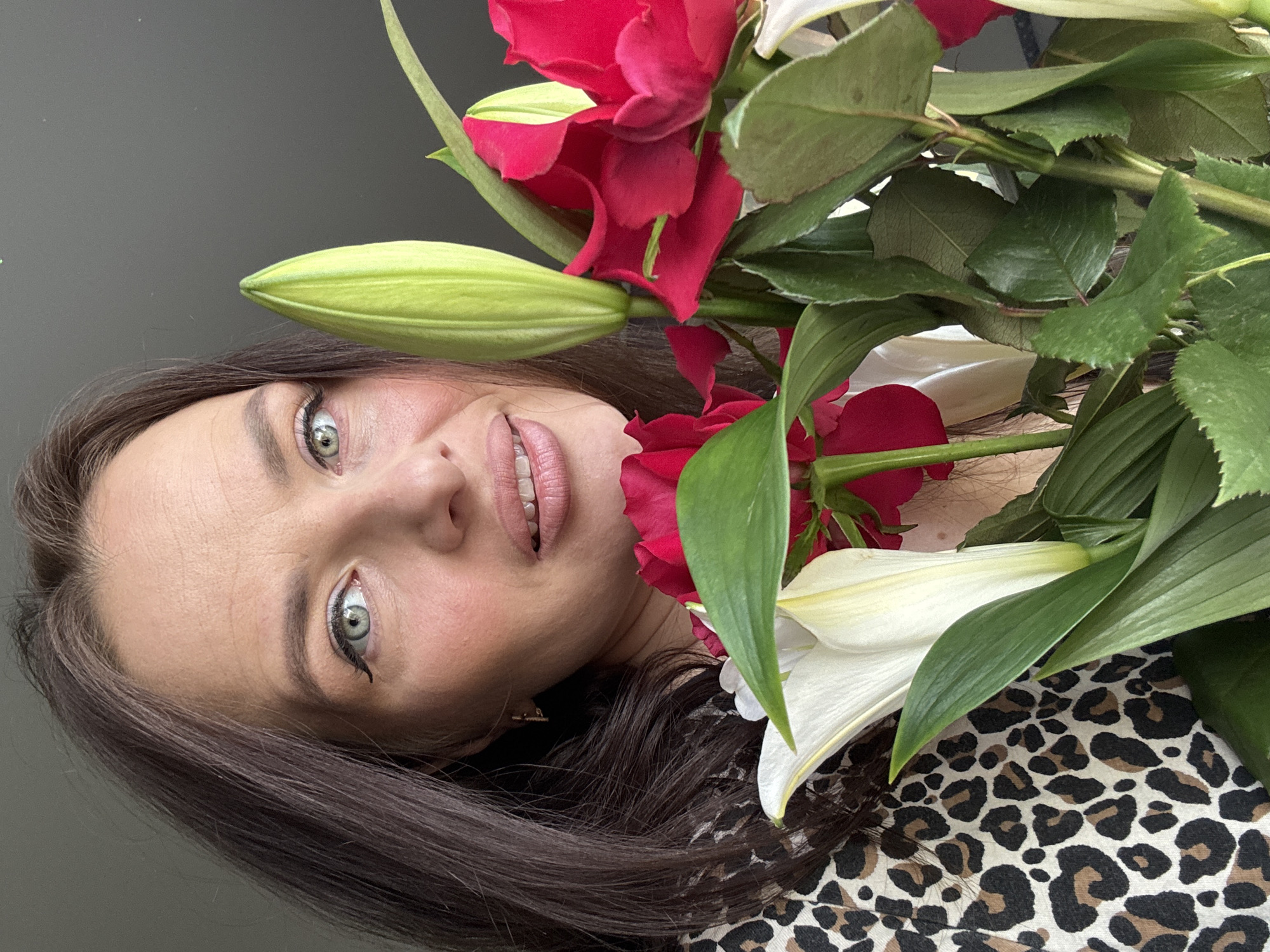 Woman poses with flower bouquet in Rusalevka portrait session