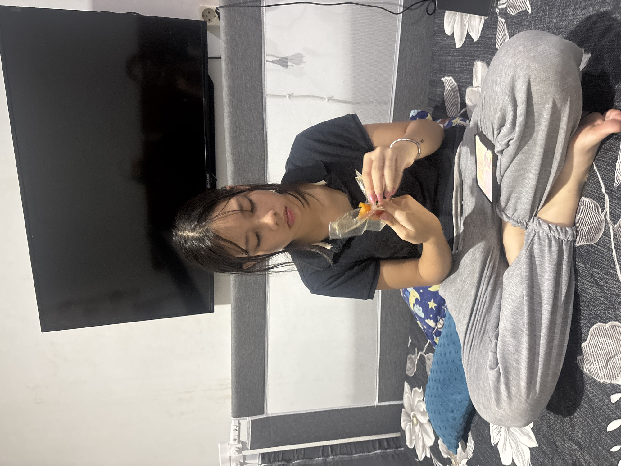 Lazy afternoon at home — snacks, a phone, and a baby being fed
