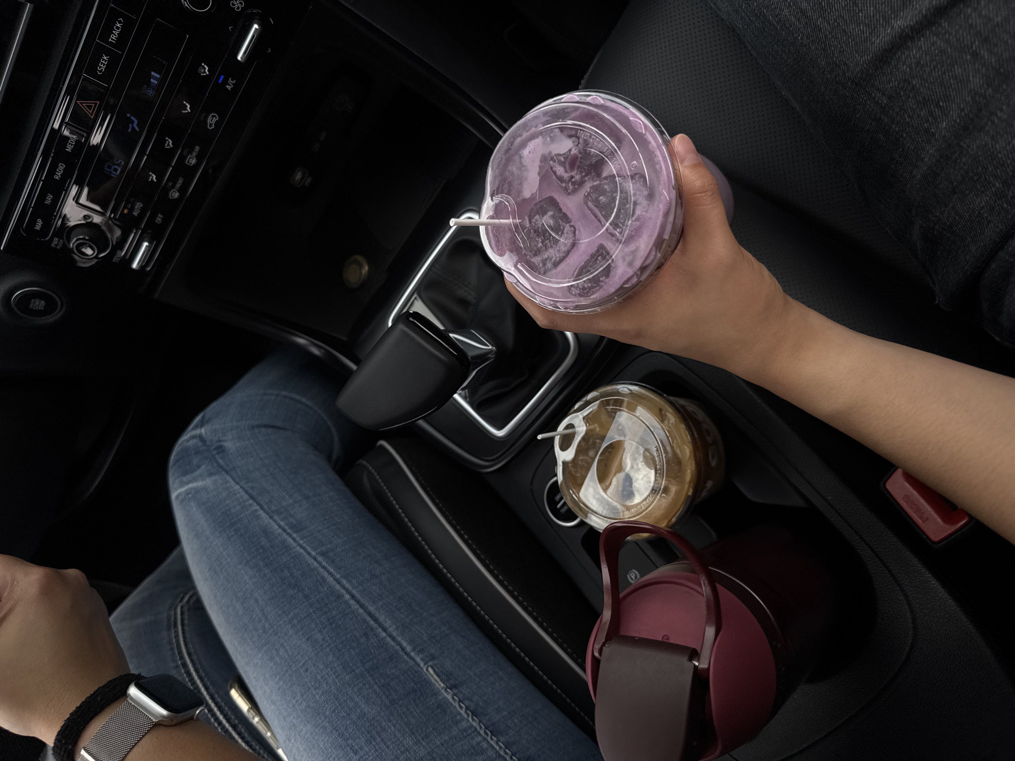 Person enjoys Woods-branded beverage inside car in Puebla