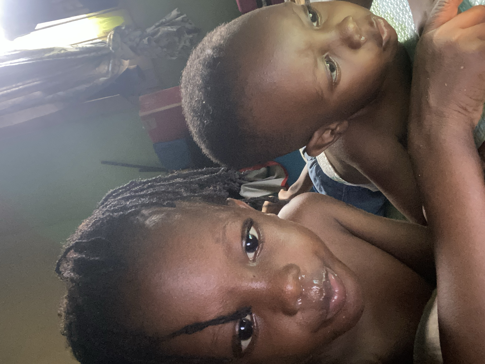 Child and adult photographed in intimate reclining moments