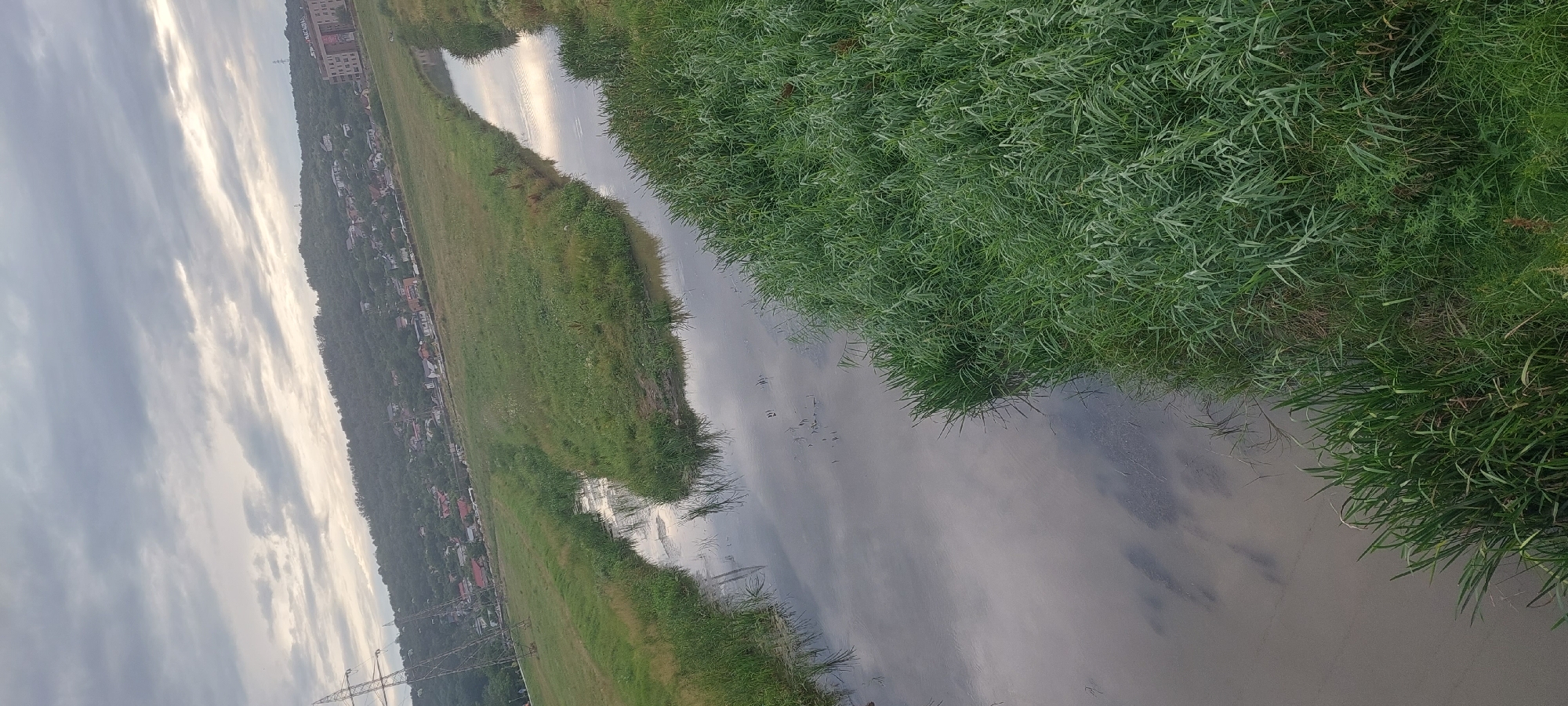 Muddy river and open skies on Iași's quiet outskirts