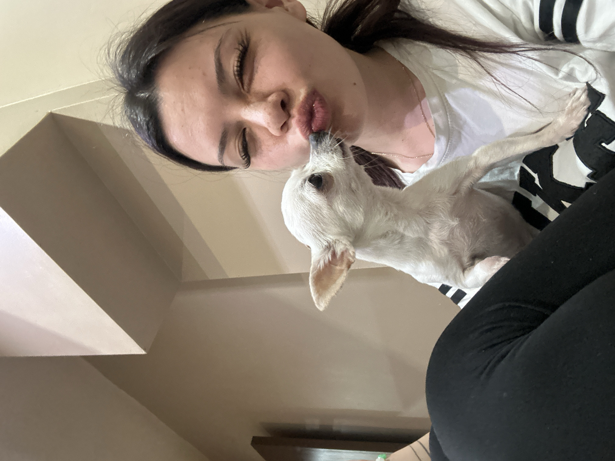 Woman photographed with white dog in Sliven, Bulgaria