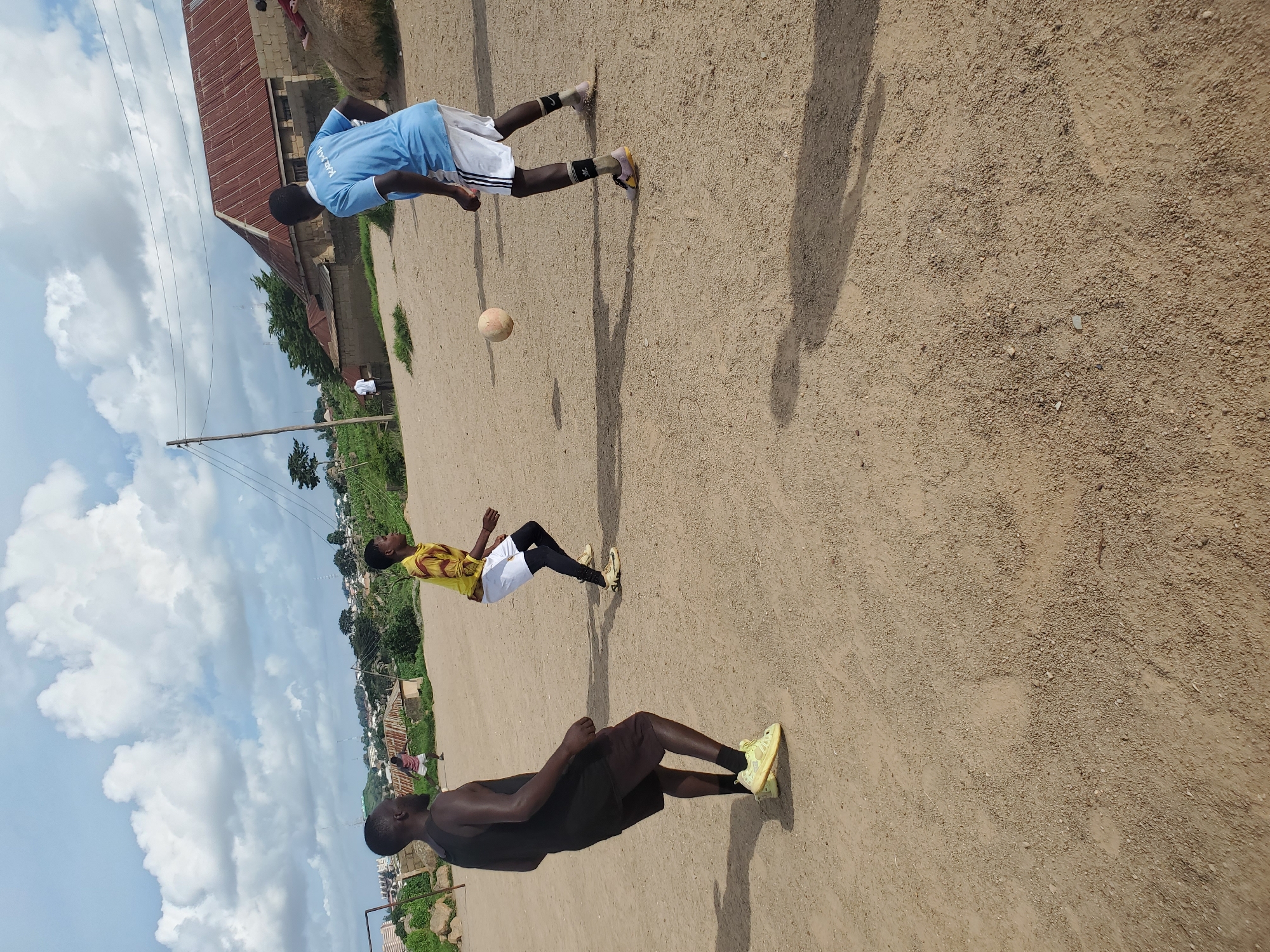Pickup soccer on a dirt field in Jos, Nigeria