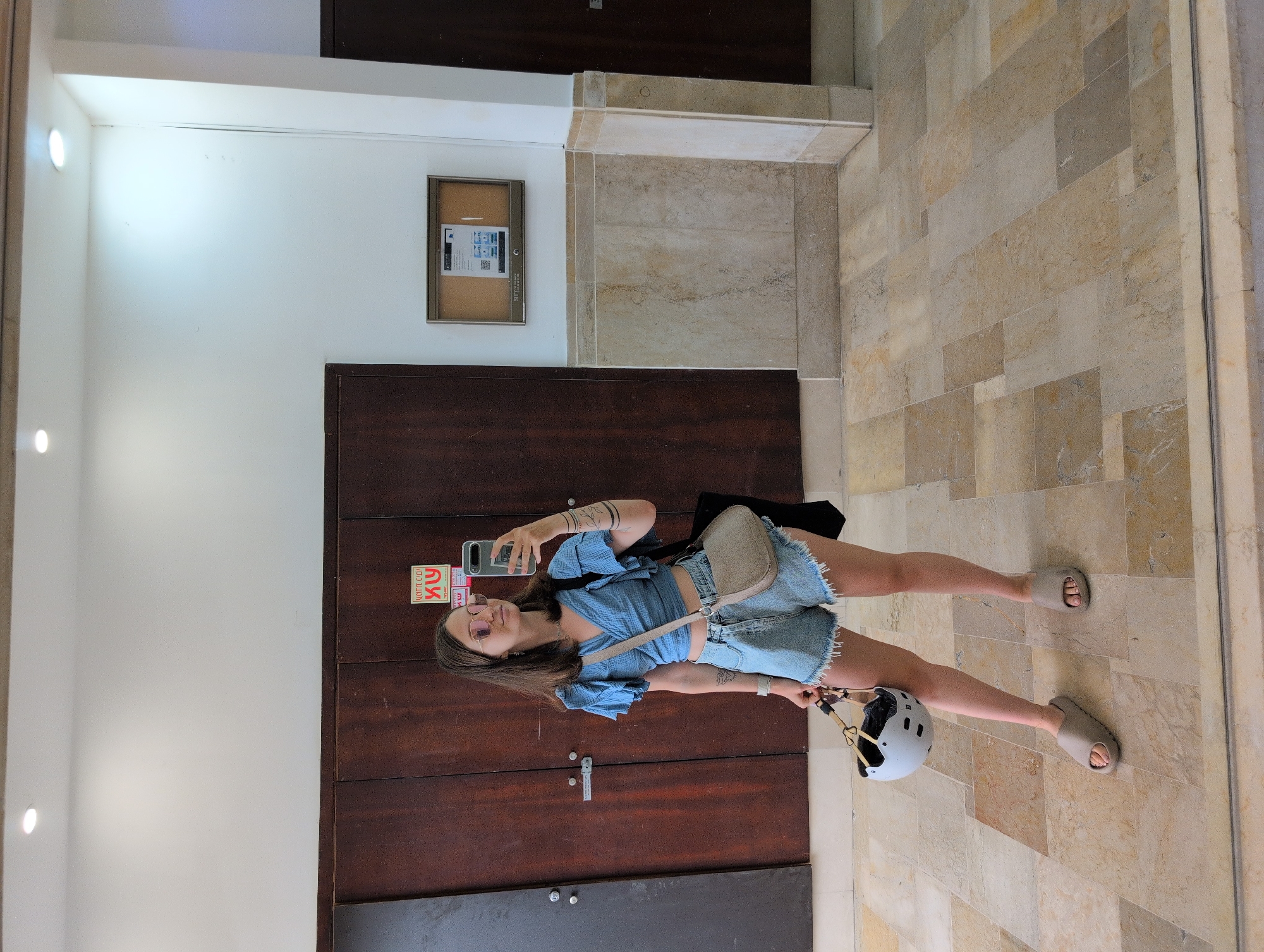 Selfie moment in a Tel Aviv hallway with wooden doors