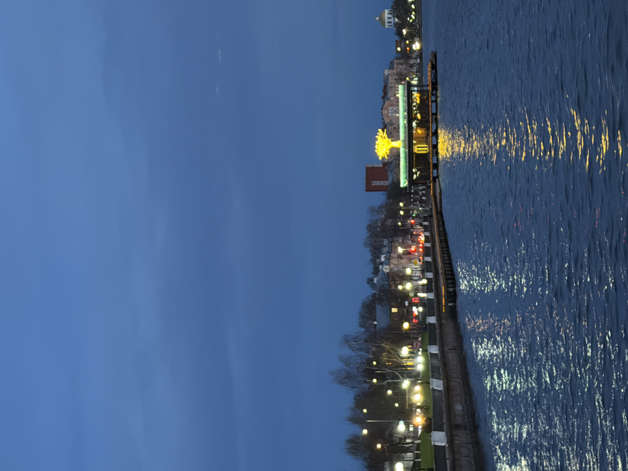 Family enjoys evening waterfront stroll in Votkinsk, Russia