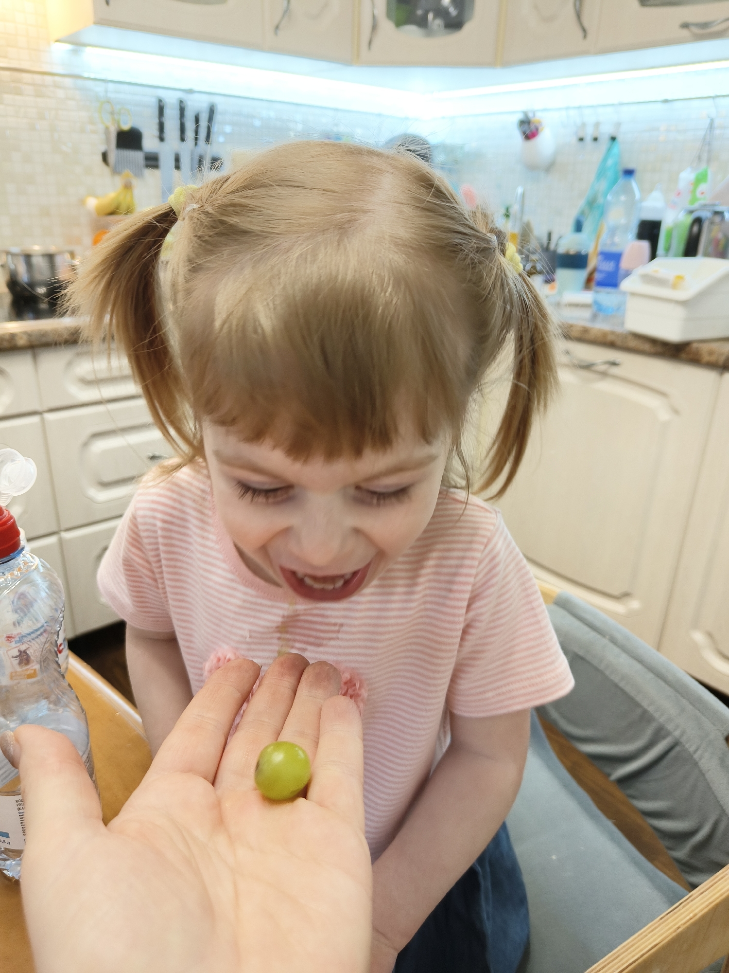 Parent prepares meal for toddler in Saint Petersburg kitchen