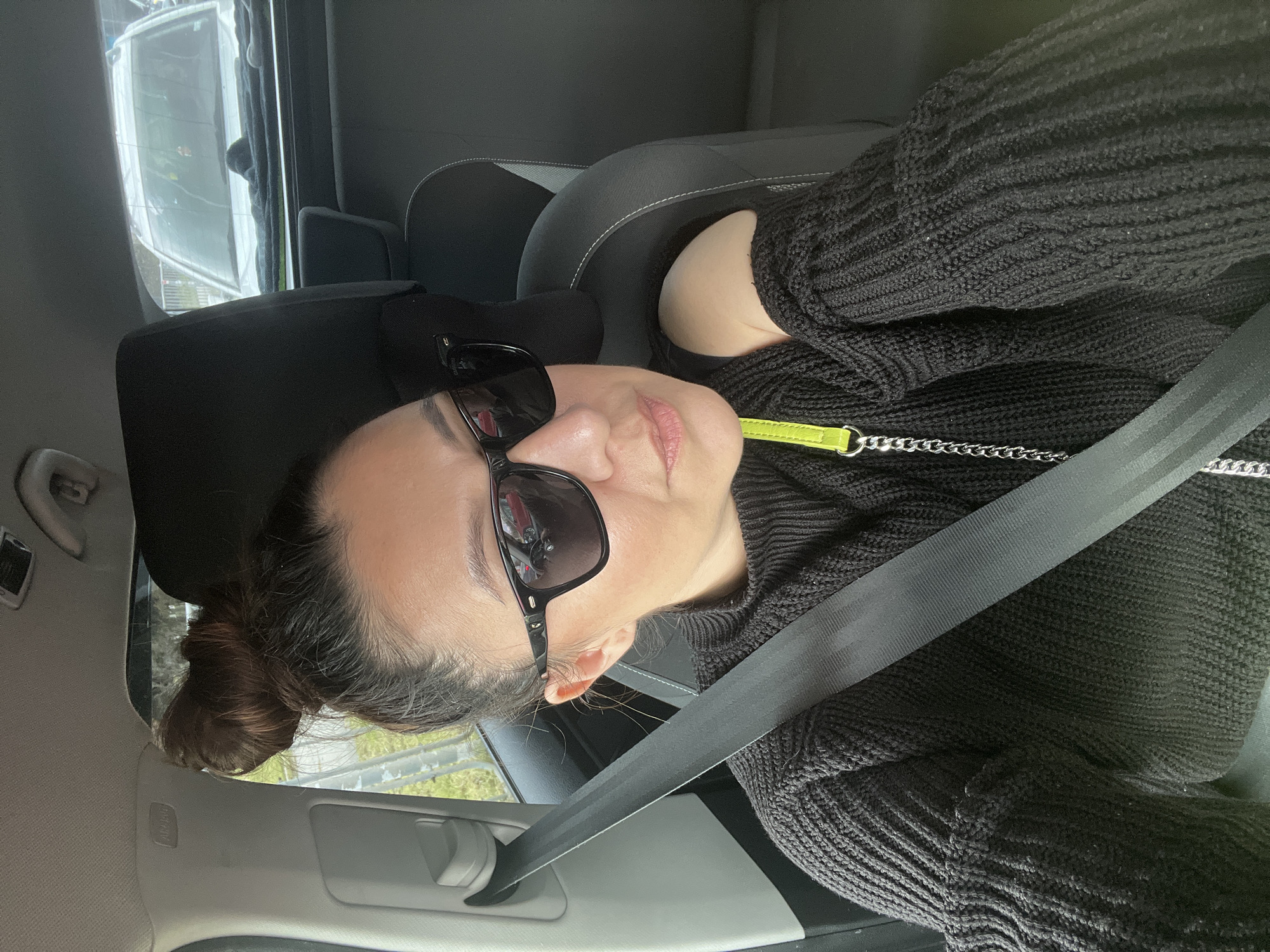 Woman in sunglasses observed seated in car in Varna