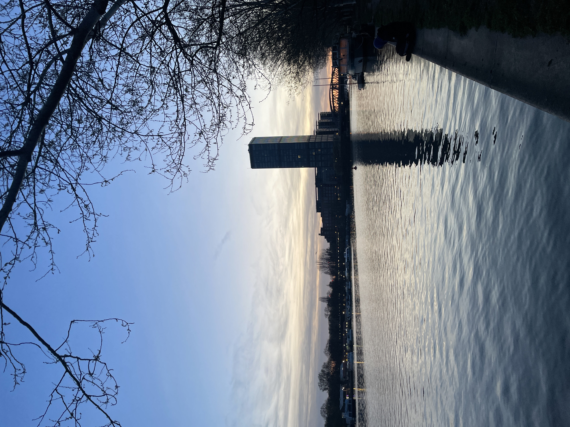 Berlin waterfront gathering captures sunset moment along city river