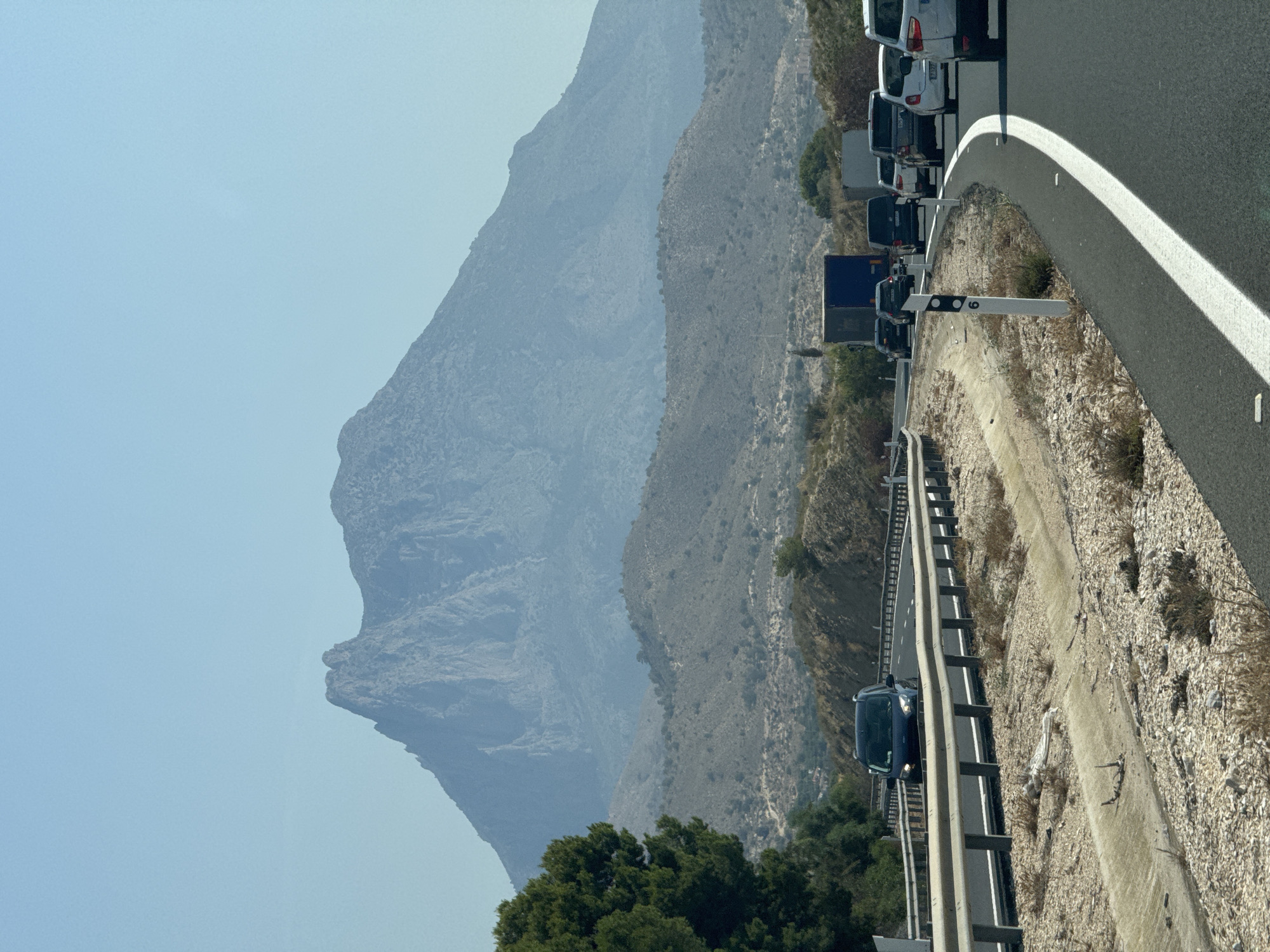Highway traffic crawls through Villajoyosa's arid mountain corridor