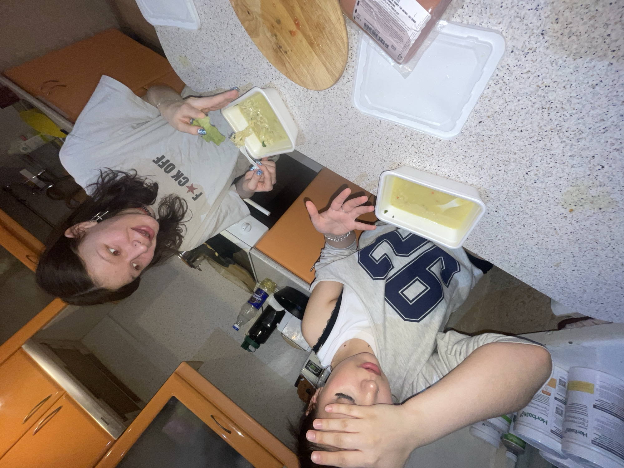 Two women photographed in Russian apartment kitchen setting