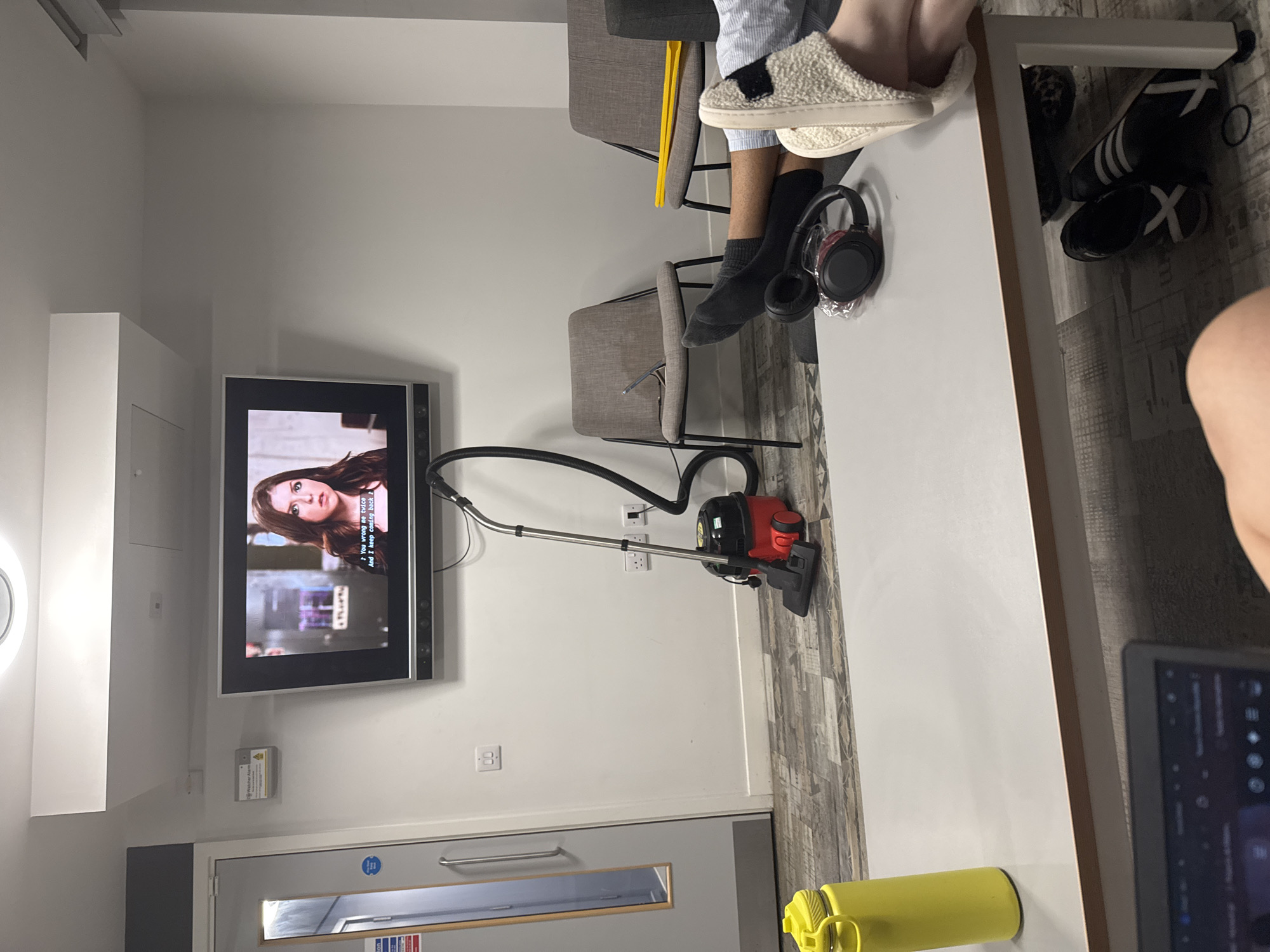Two people relax in Hull common room late evening