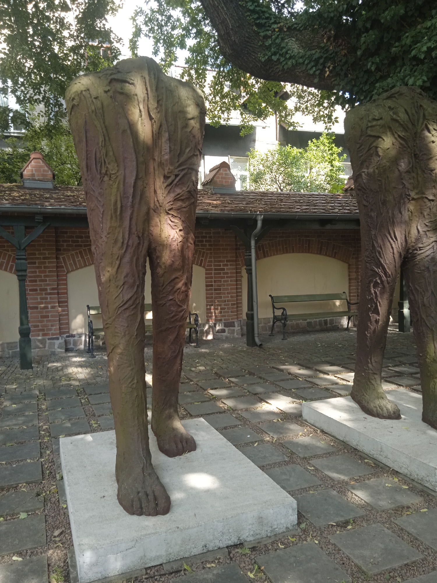 Historic campus with classical buildings, gardens, and abstract sculpture