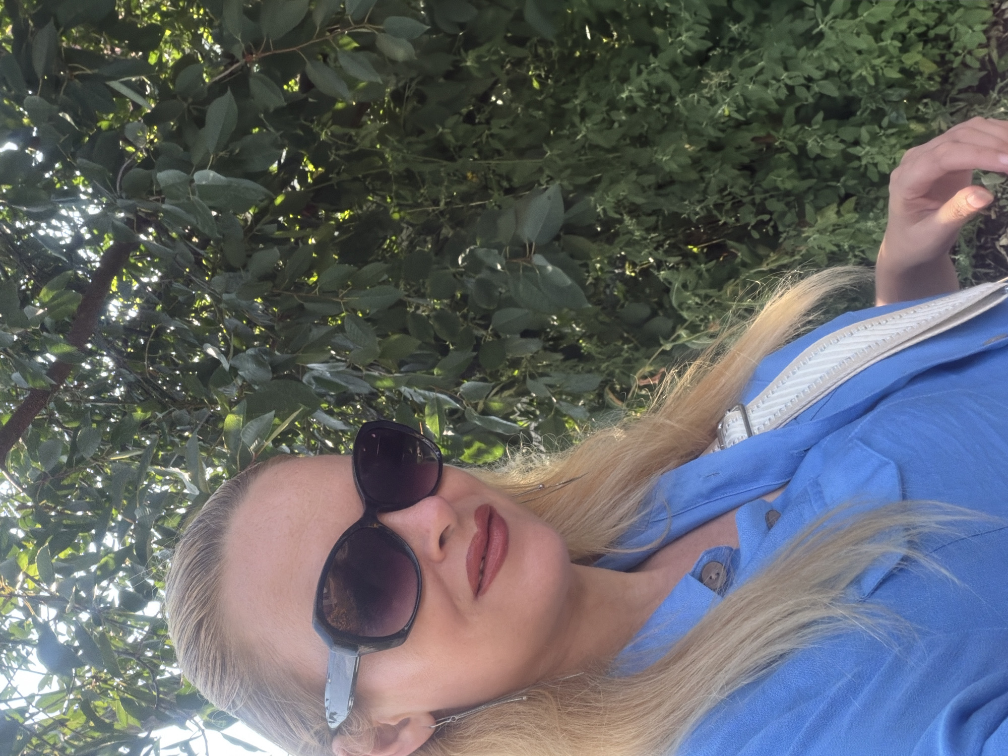 Selfie session outside a pink brick building, blue shirt and shades