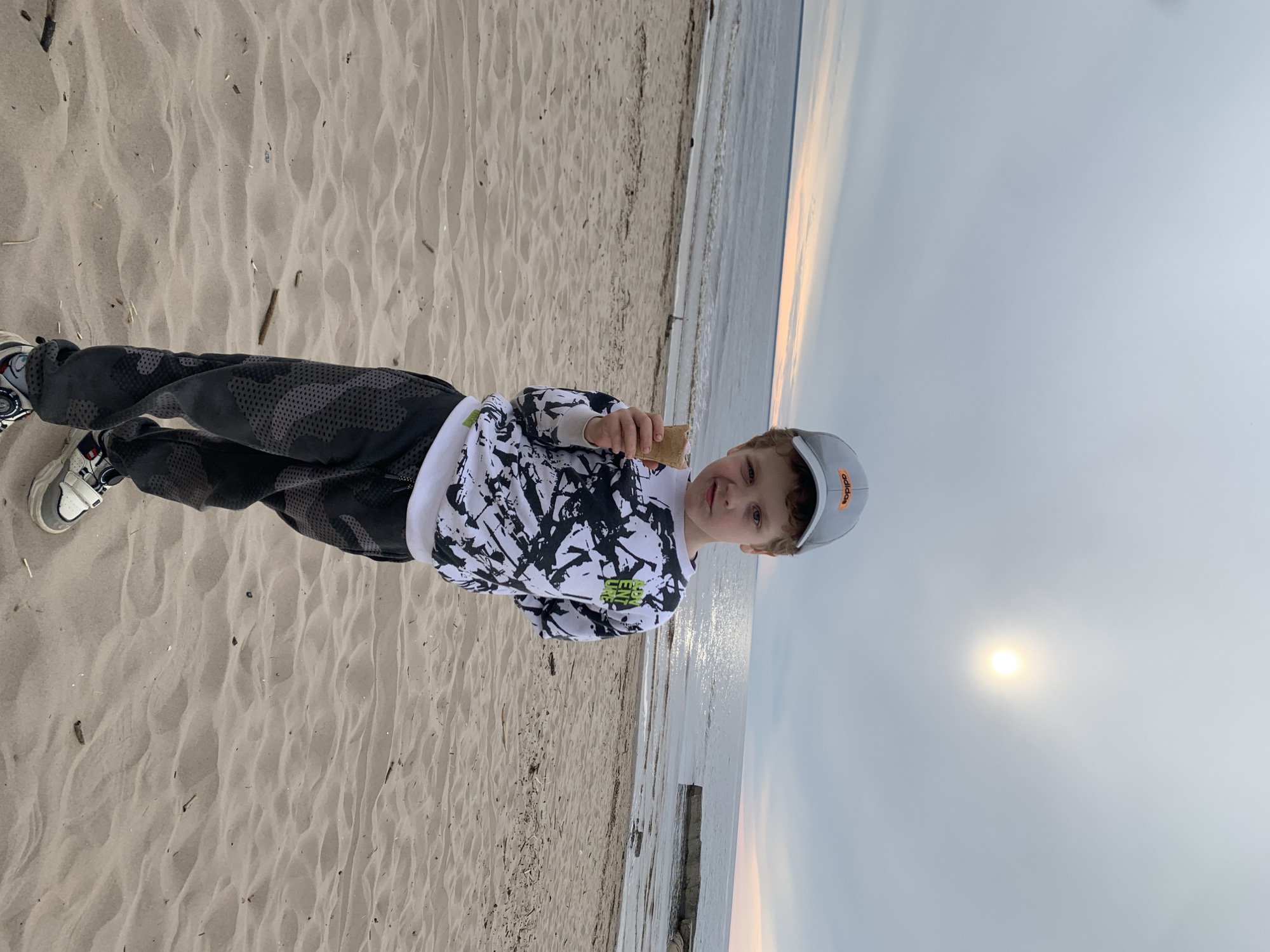 Boy enjoys sunset beach moment in Severodvinsk
