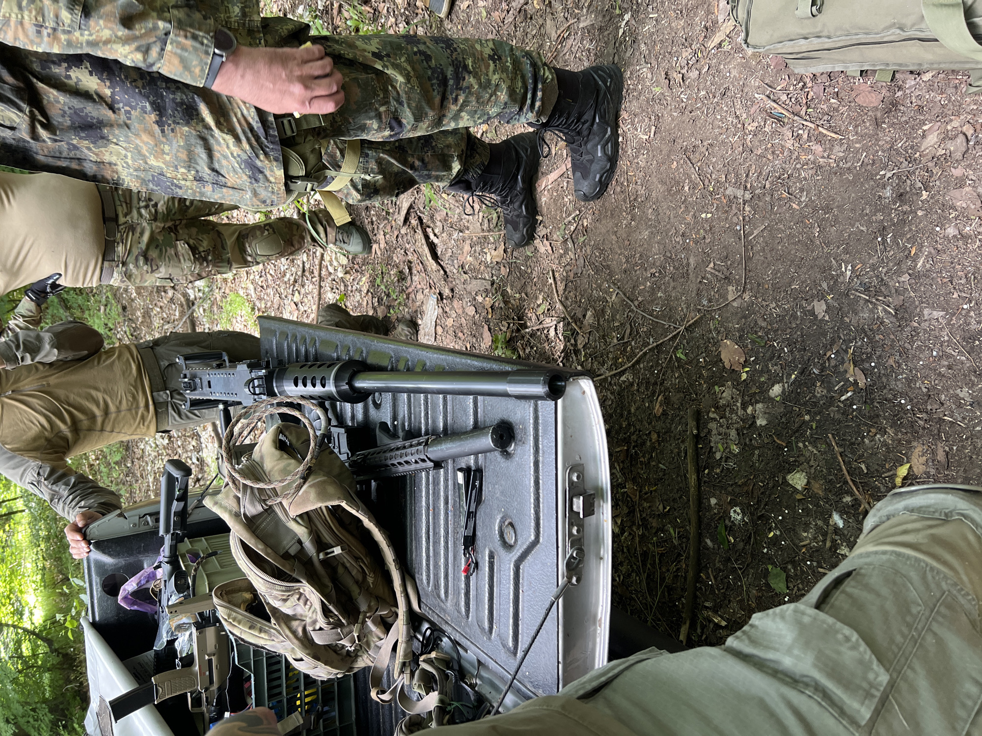 Armed individuals in tactical gear observed in wooded area