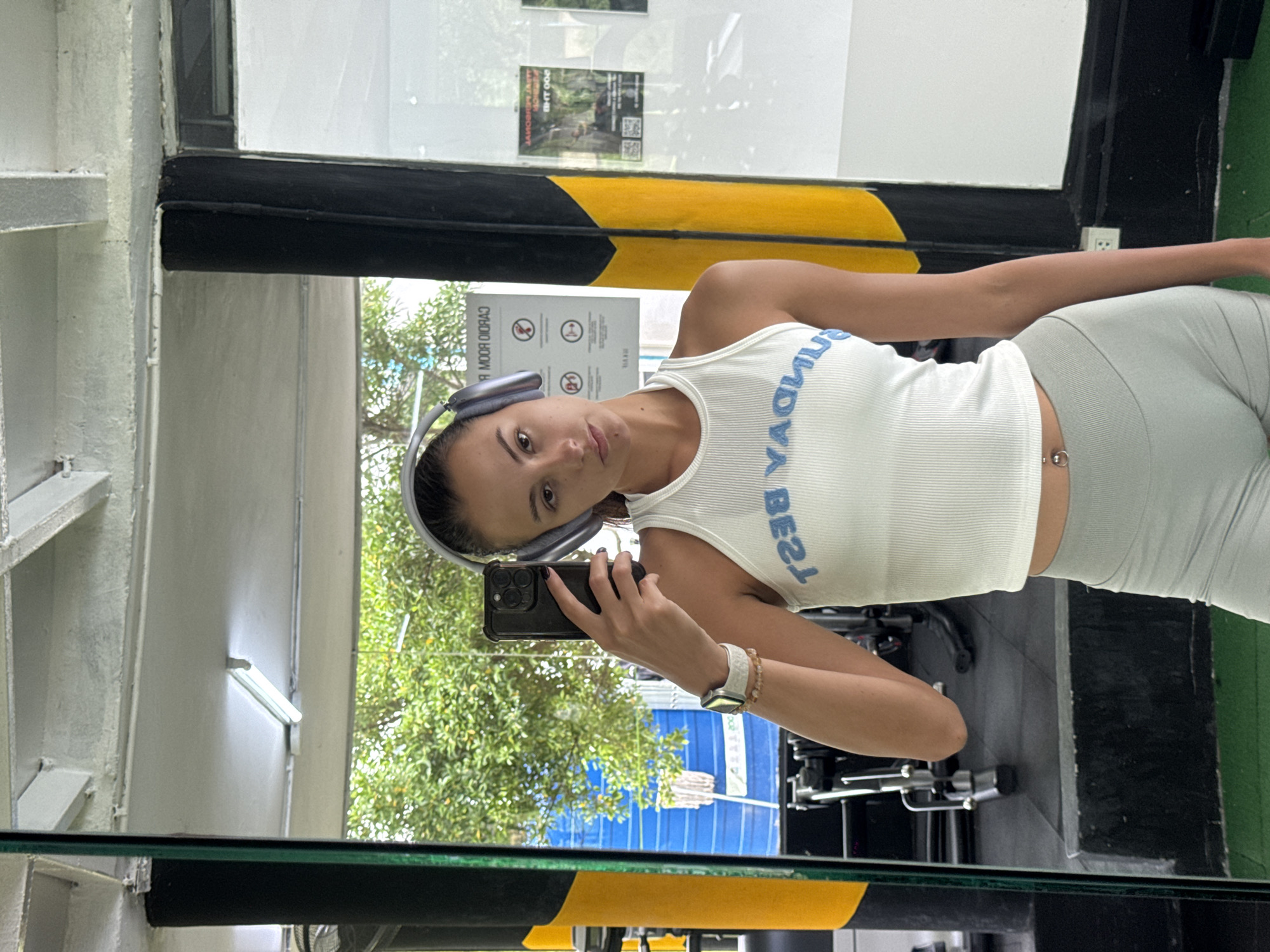 Woman takes gym selfies in Kathu, Thailand early morning