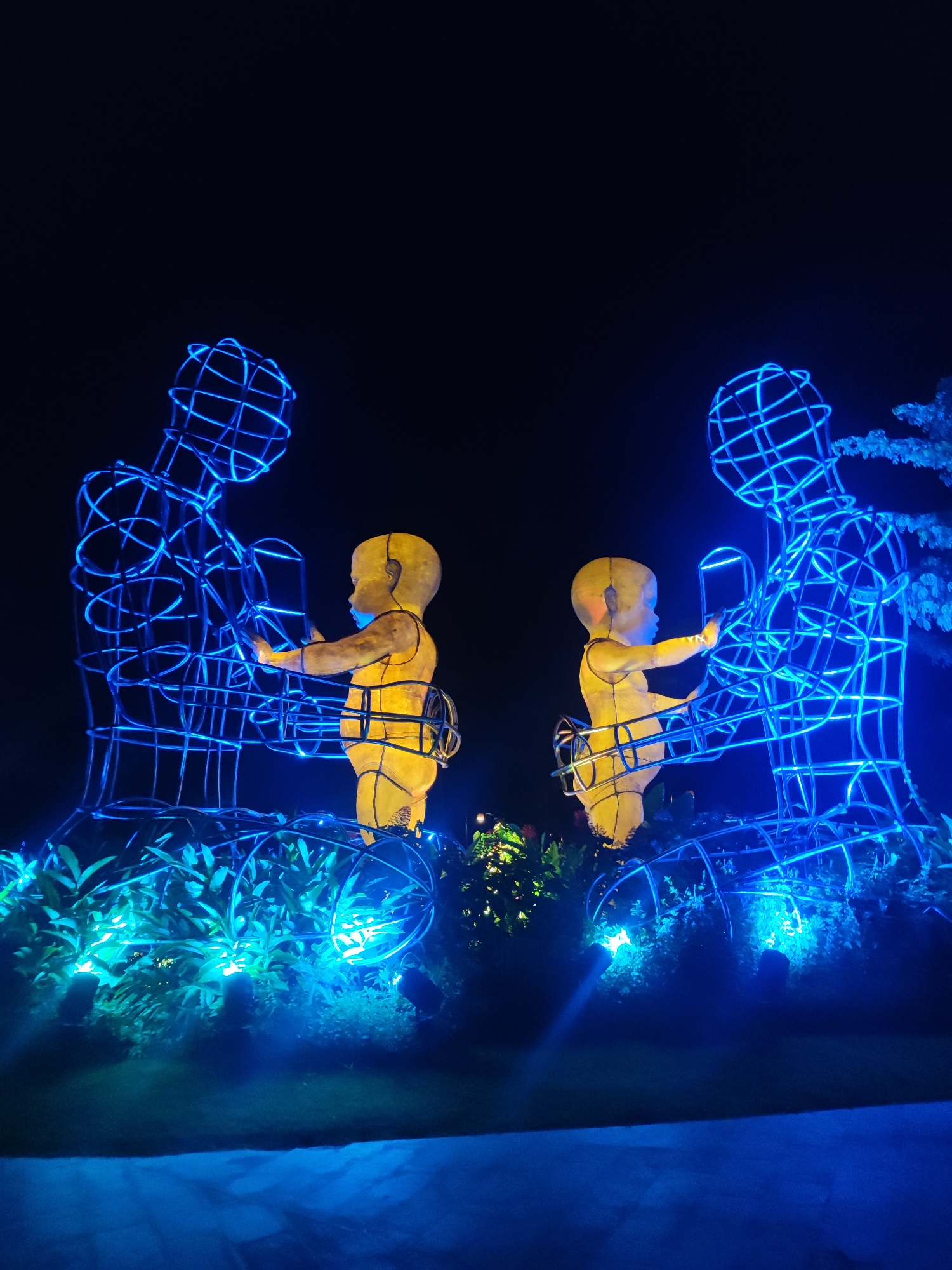 Visitors explore glowing circular art installations in Indonesian garden