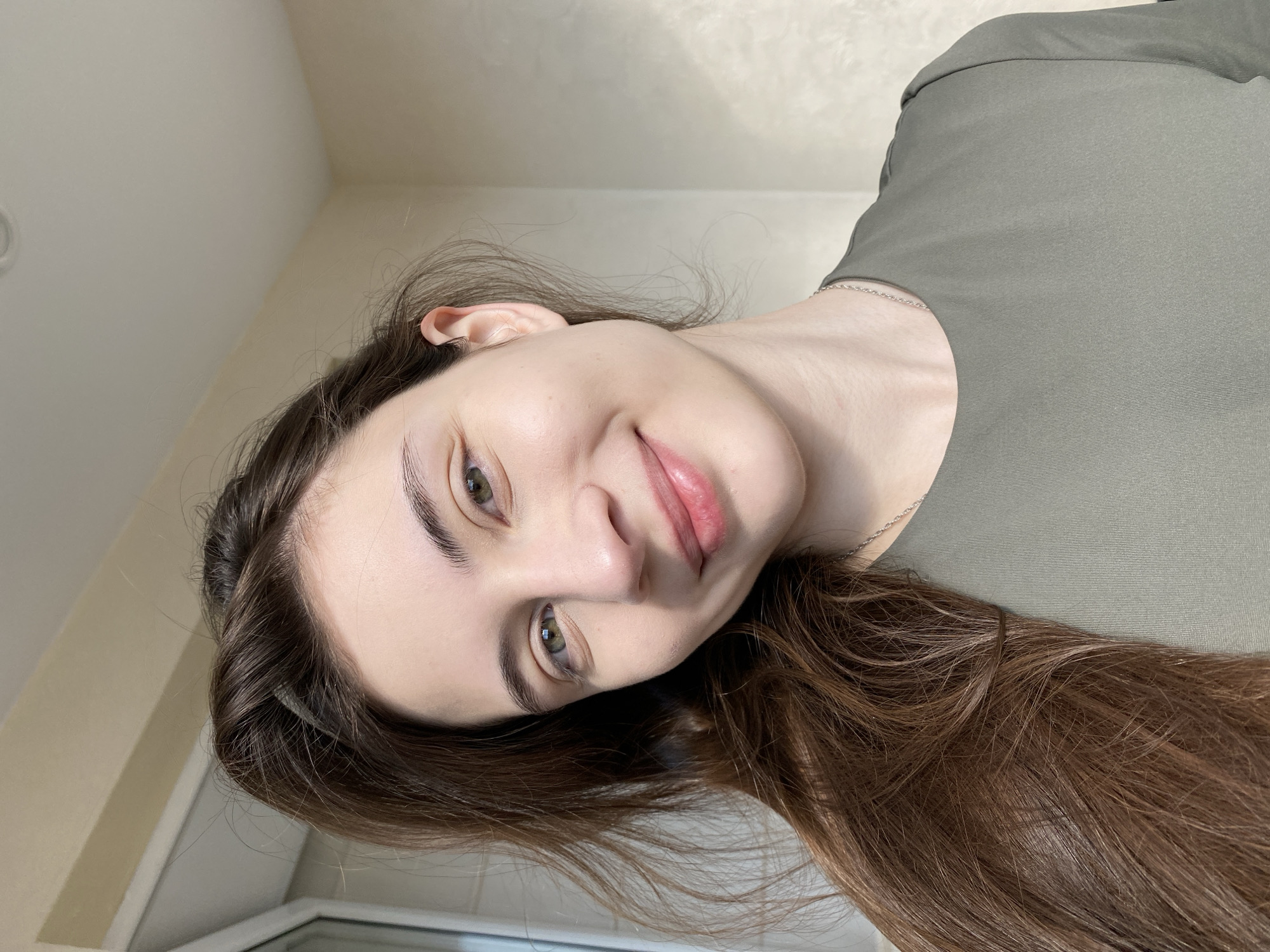Young woman photographed in multiple indoor portraits in Votkinsk