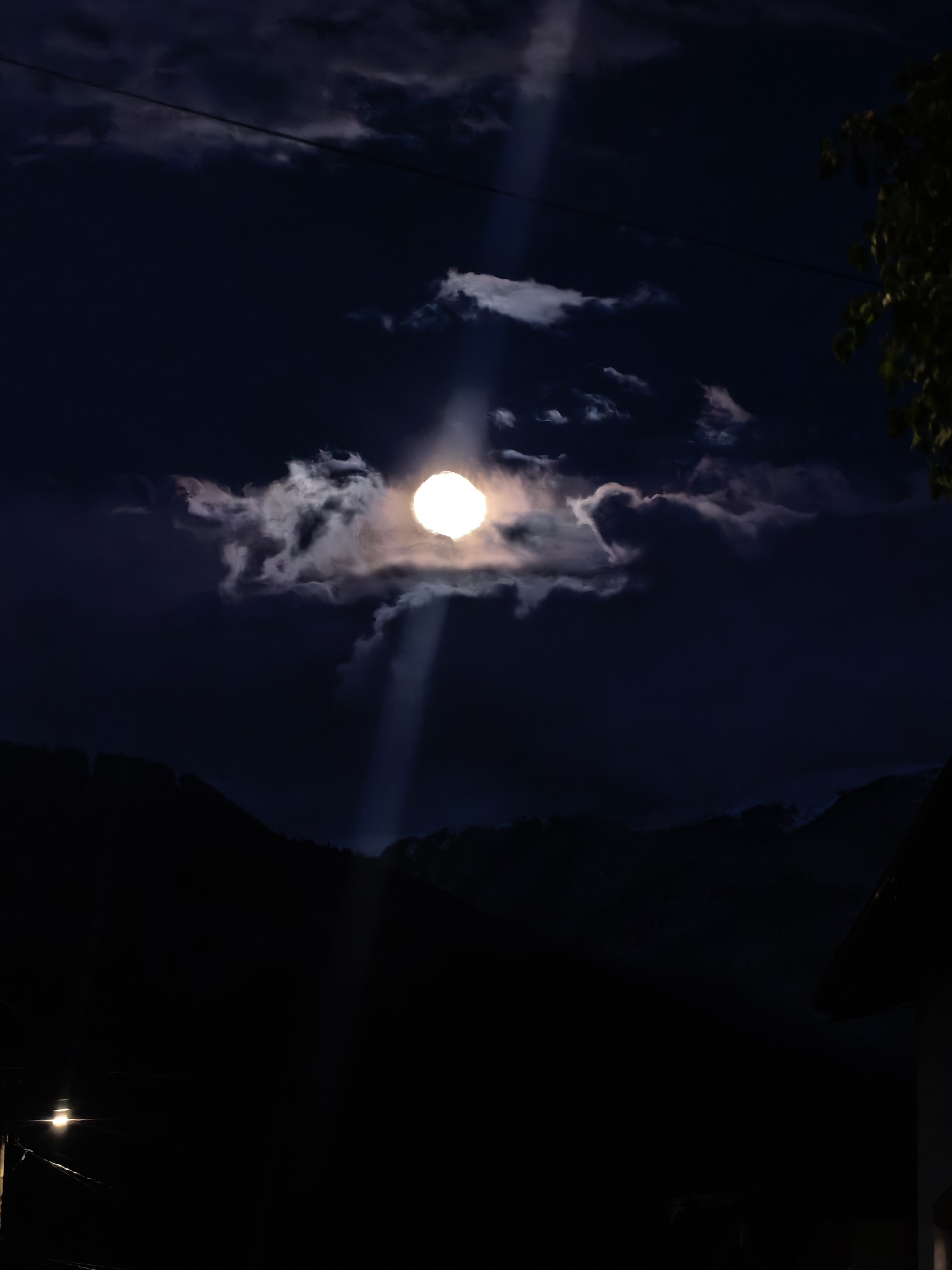 Full moon illuminates cloudy mountain skies over Samoranovo, Bulgaria