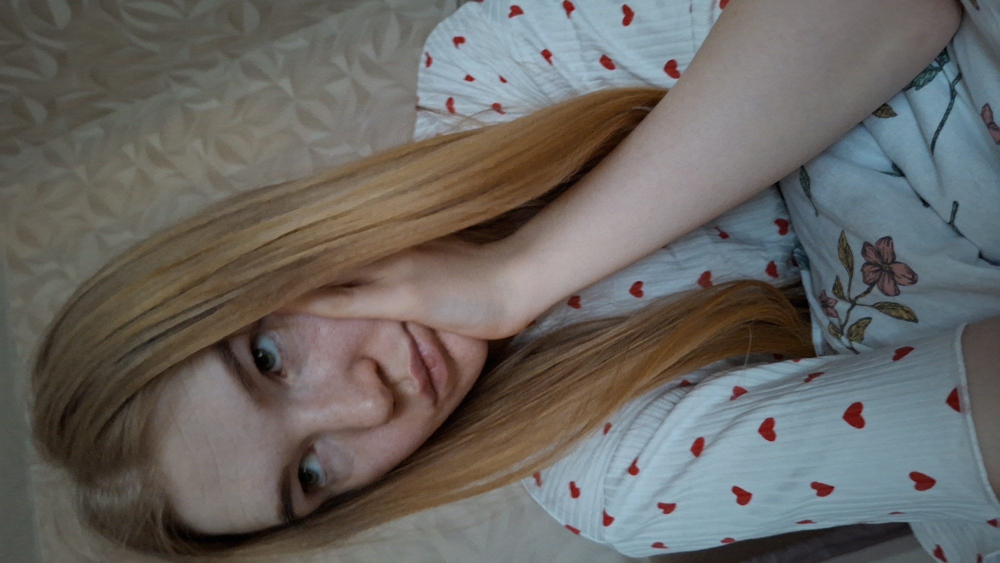 Woman in heart-patterned pajamas observed resting in Chaikovsky bedroom