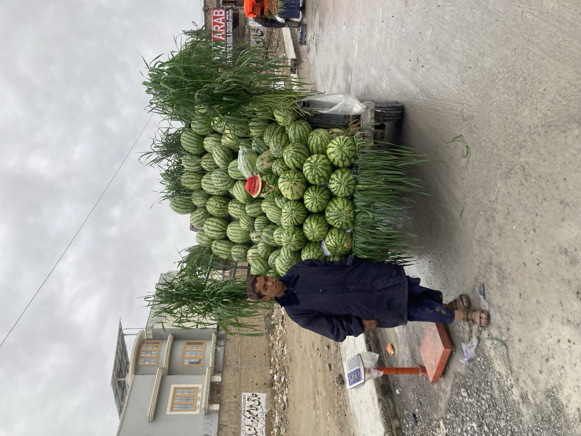 Street vendor sells watermelons from cart in Quetta