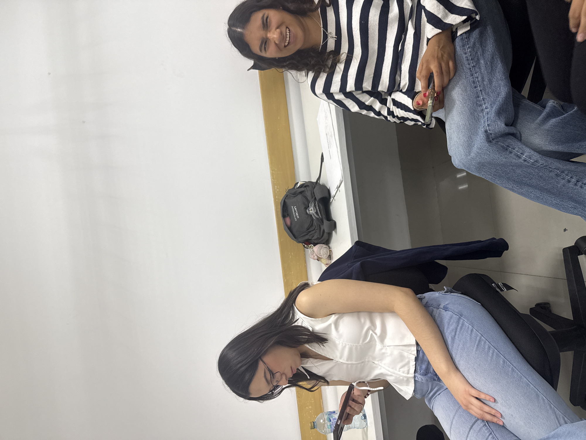 Students study construction models in classroom setting