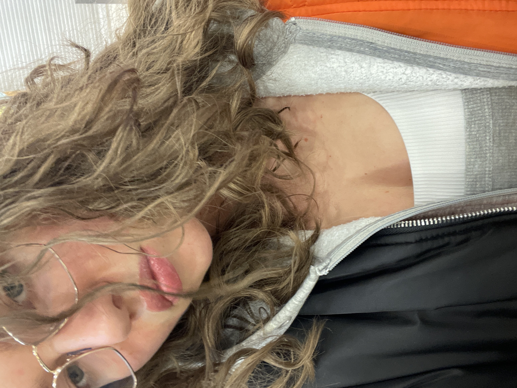 Person takes selfie in Moscow wearing glasses and tank top