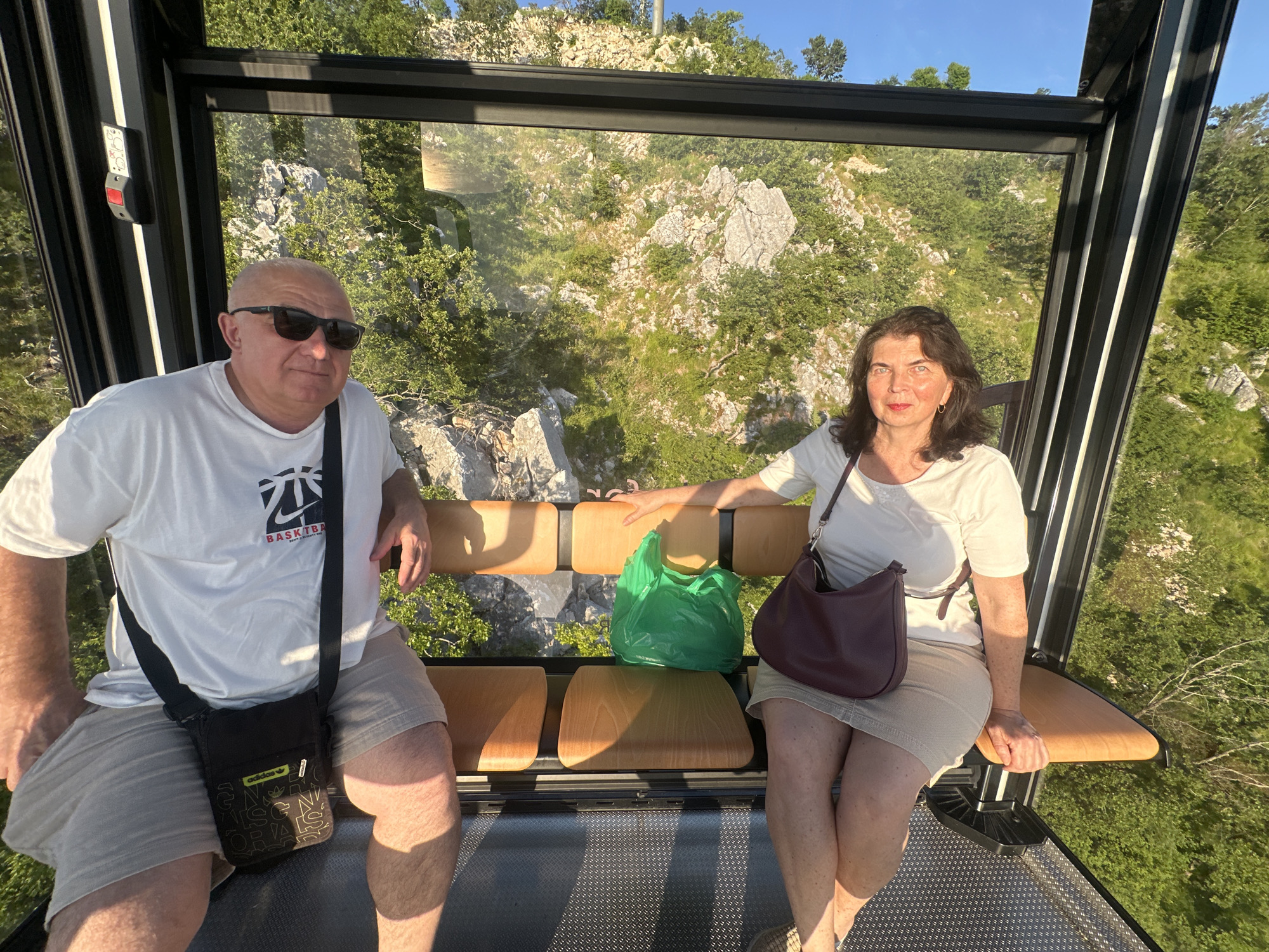 Cable car riders enjoy sunset views over Montenegro coast