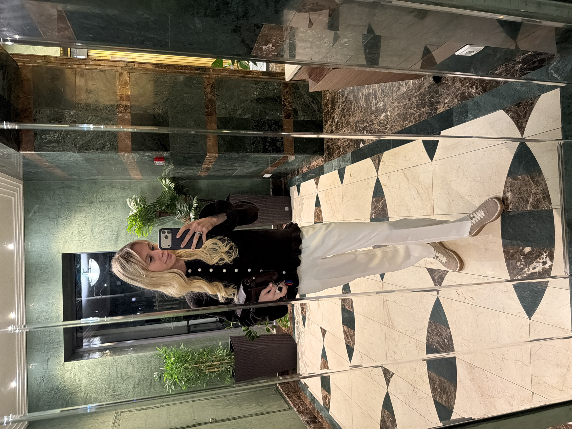 Woman takes selfie in mirrored elevator in Moscow