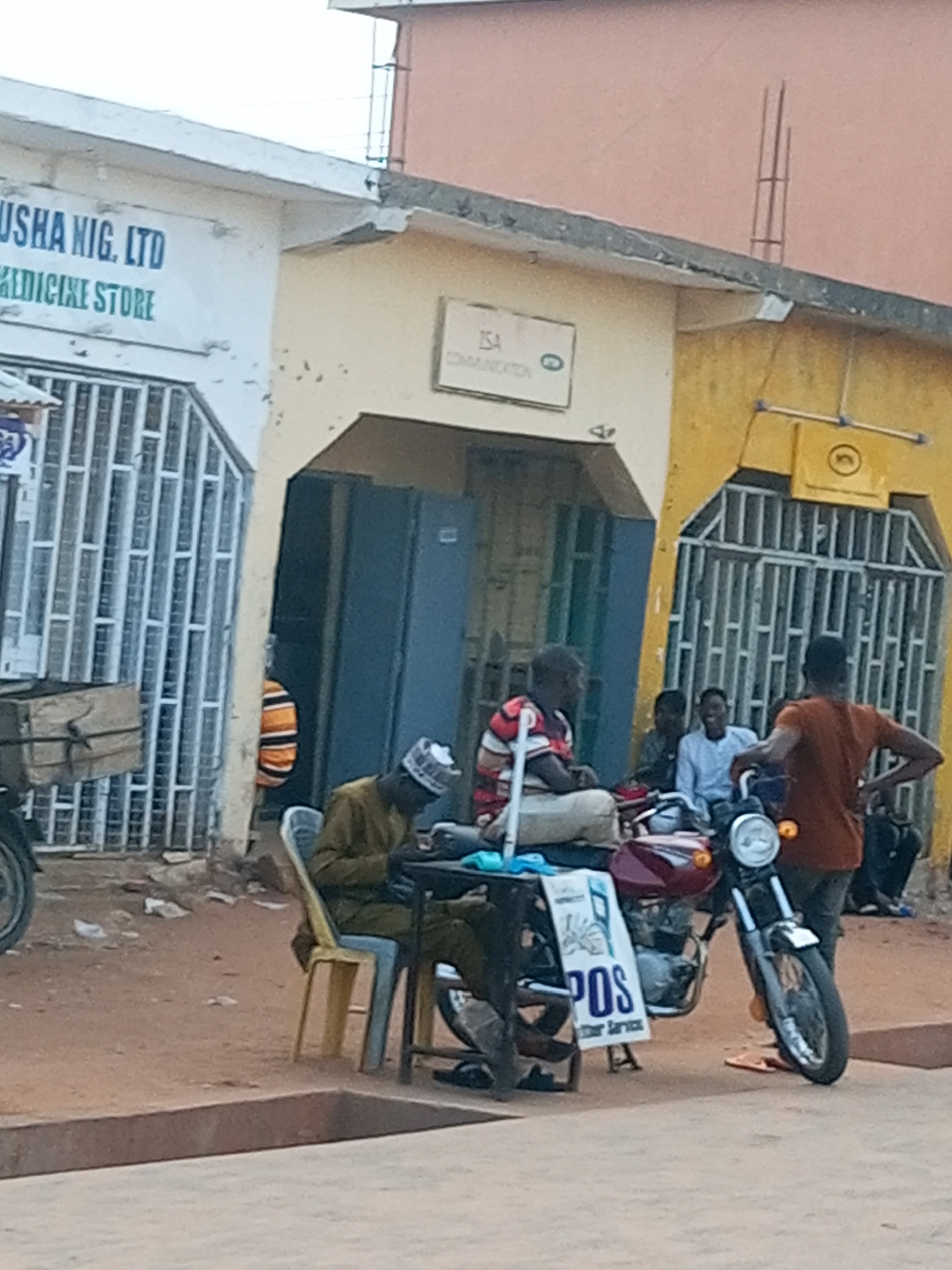 Street life and motorcycle activity in a busy market area