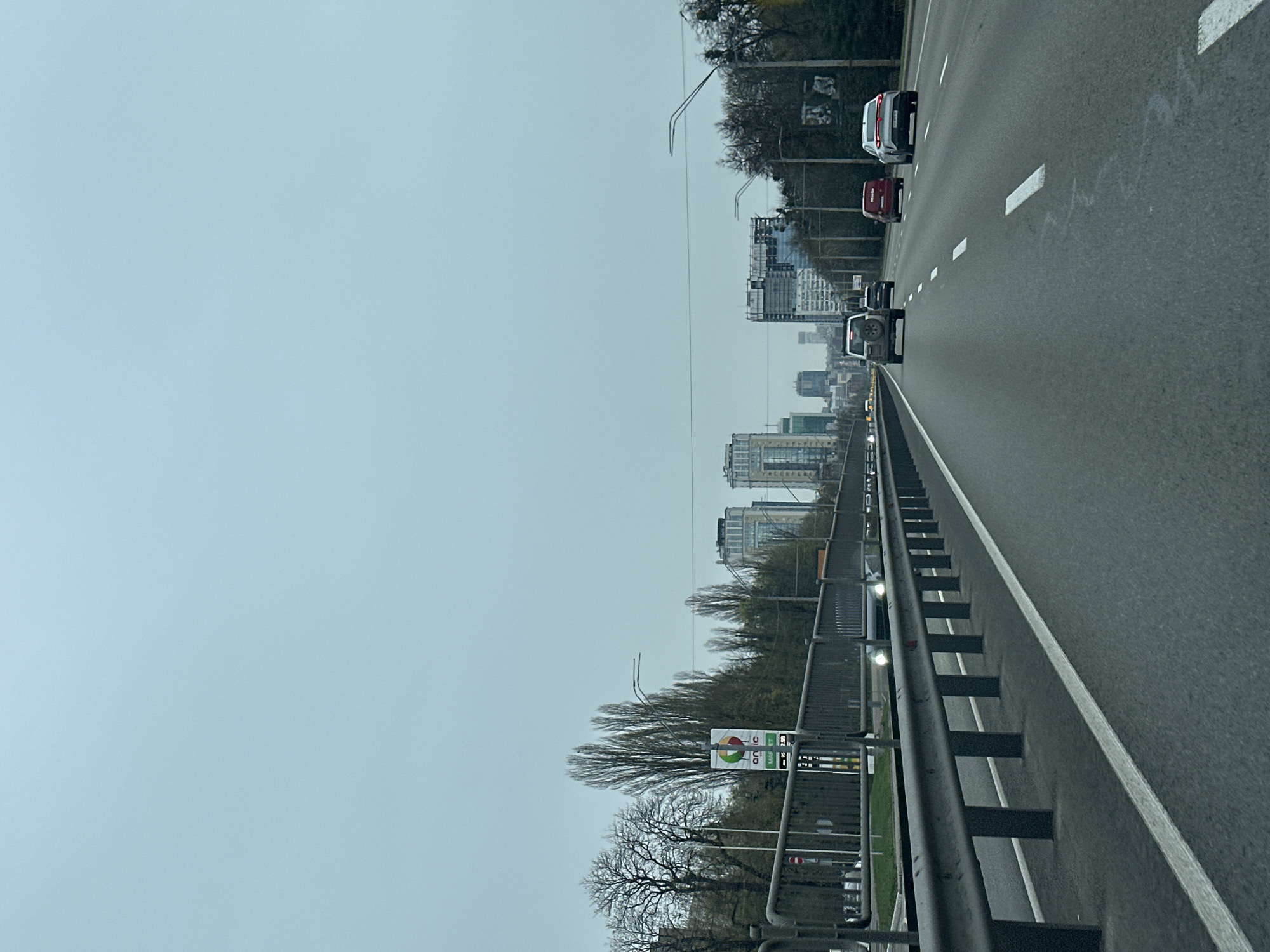 Morning traffic flows past modern architecture in Kyiv