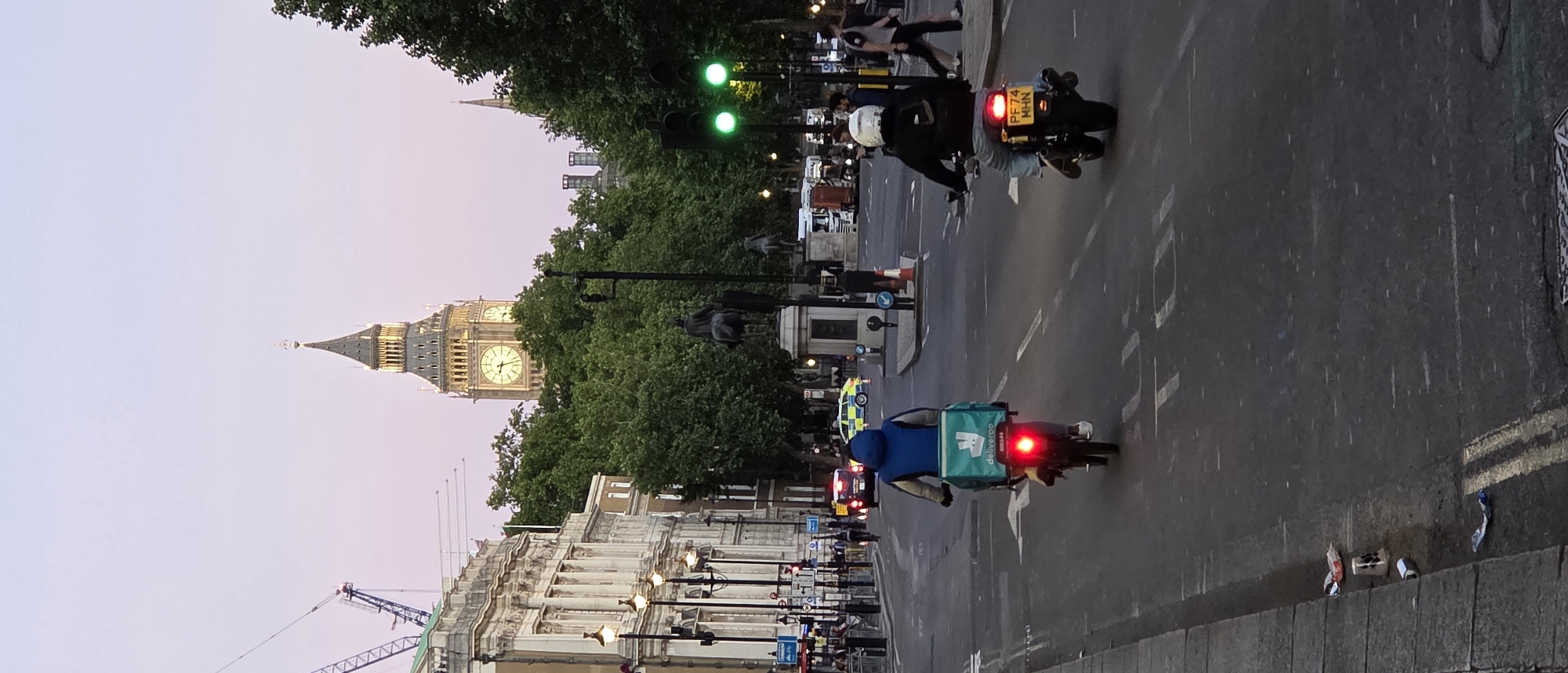 Big Ben illuminated at twilight draws multiple observers
