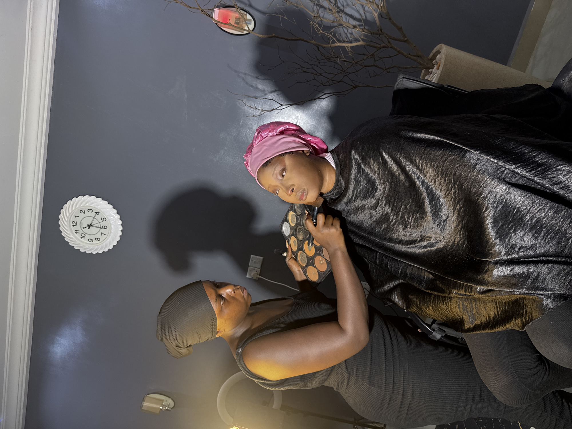 Makeup session in a home studio, Gura Top, Nigeria