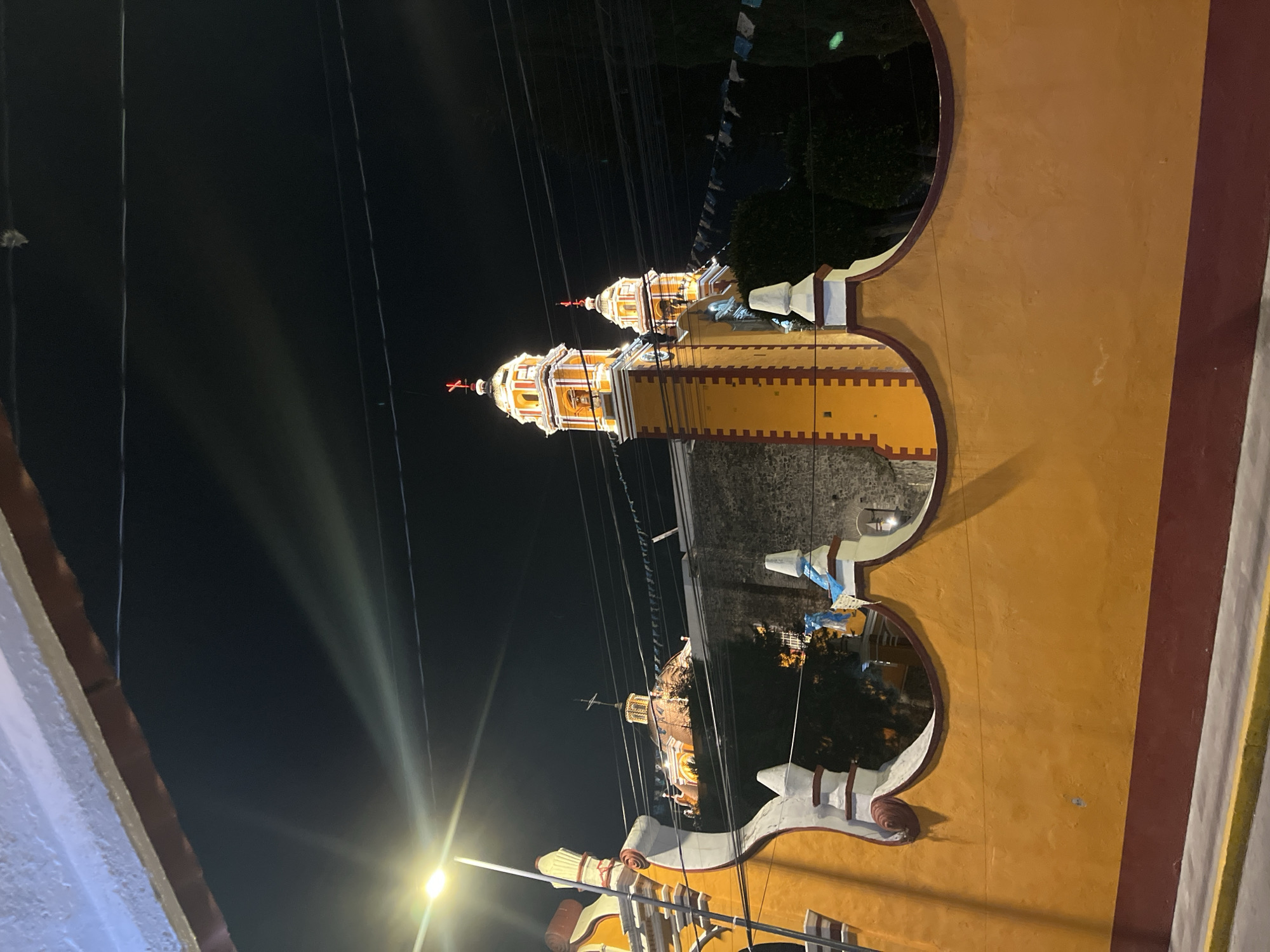 Nighttime church view captured through decorative archways in Mexico