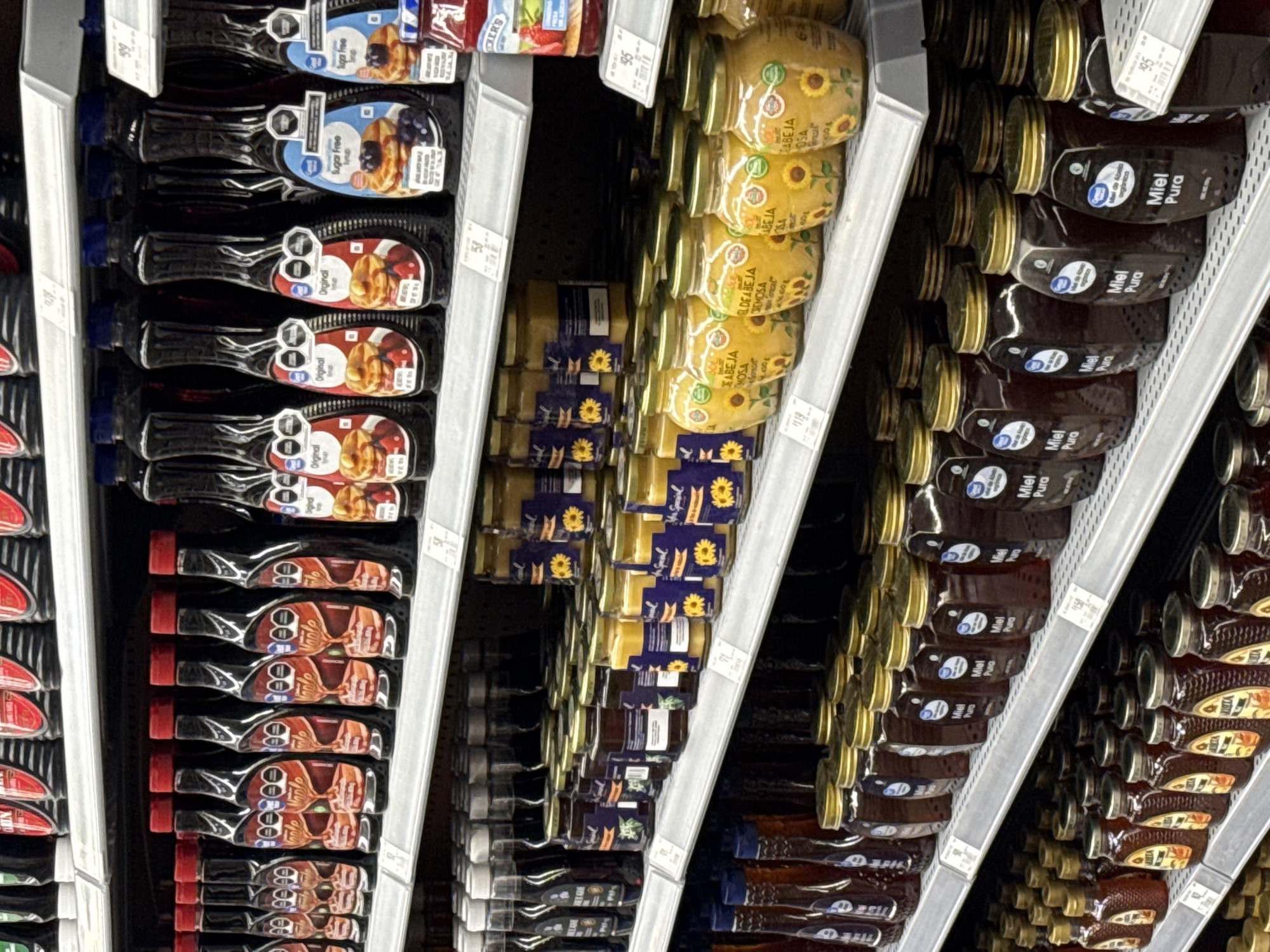 Grocery store stocks syrup and honey aisle in Puebla