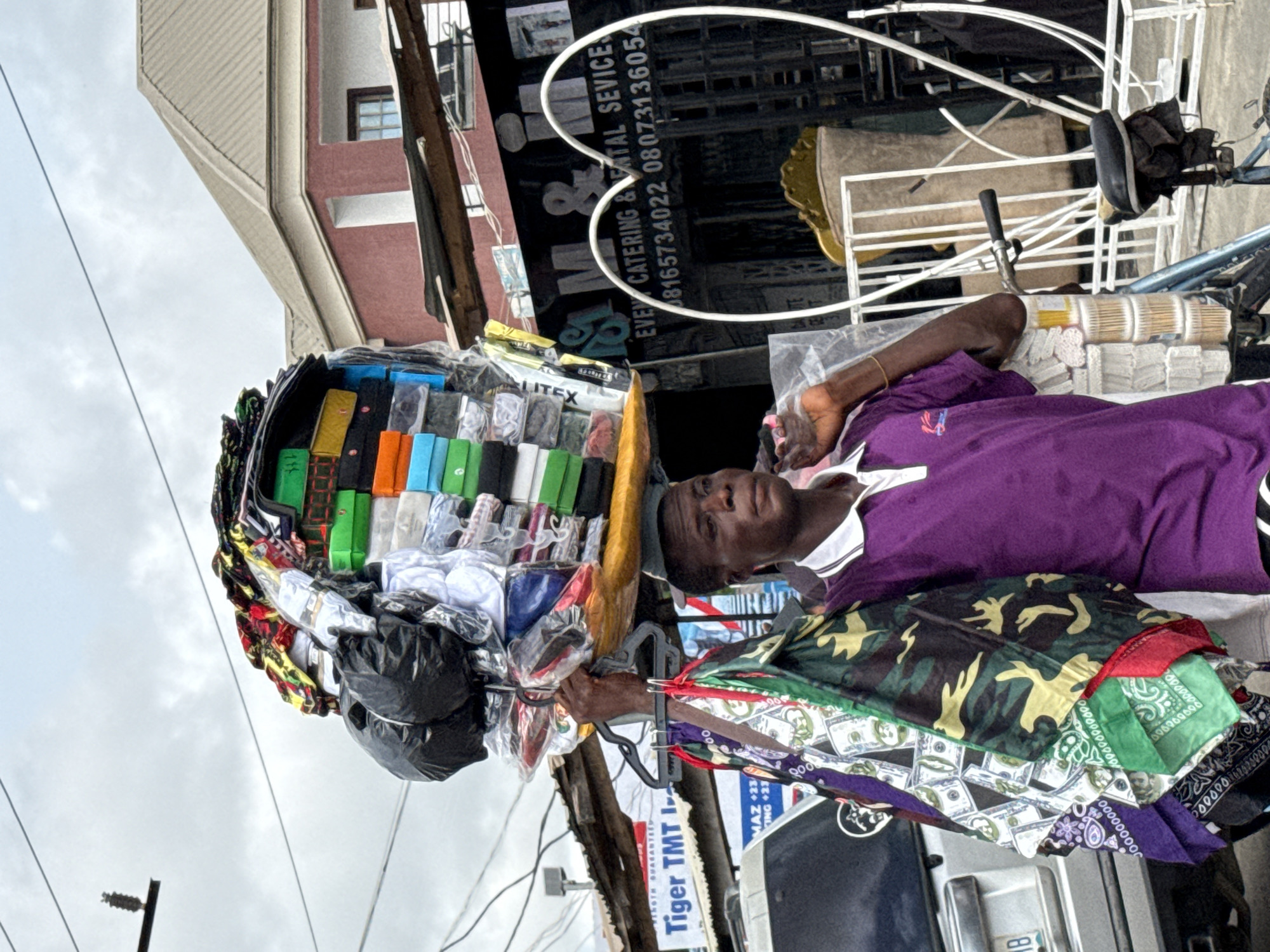 Vendor rests during goods transport in Ado, Nigeria