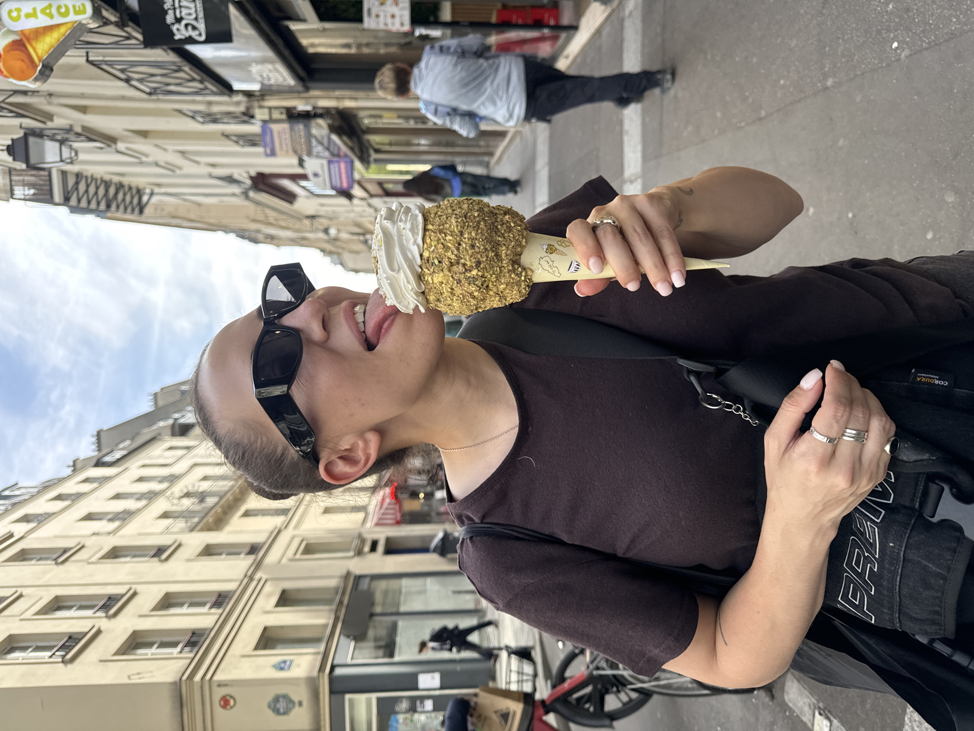 Woman enjoys ice cream on Paris street