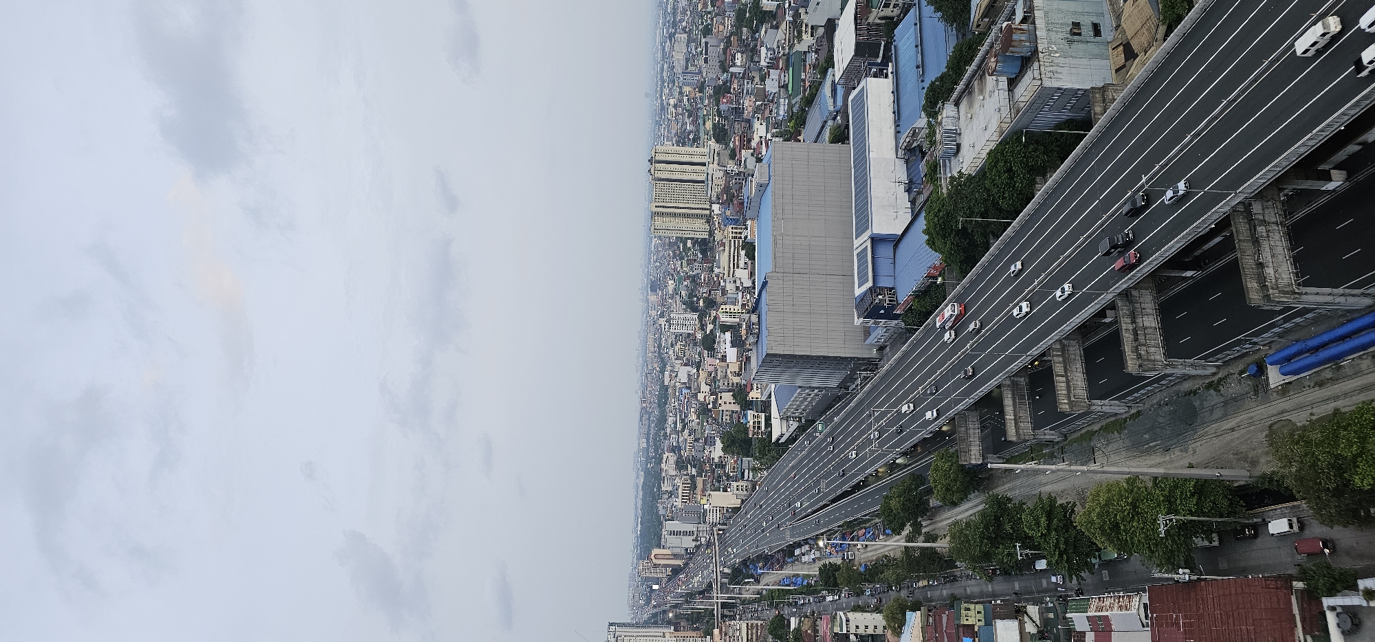 Aerial pass over Makati's elevated highway and cityscape