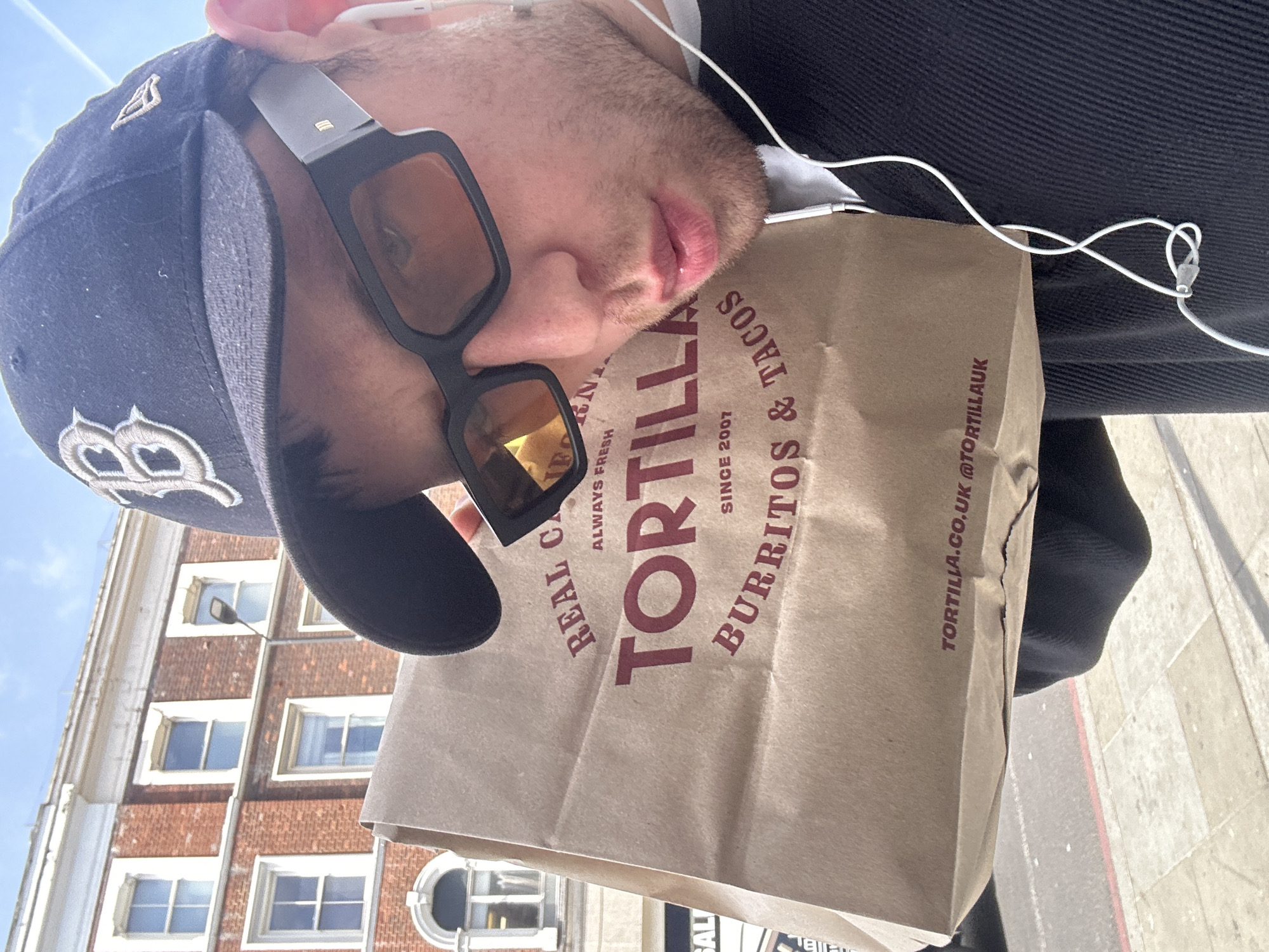 Man photographed carrying takeout bag on London sidewalk