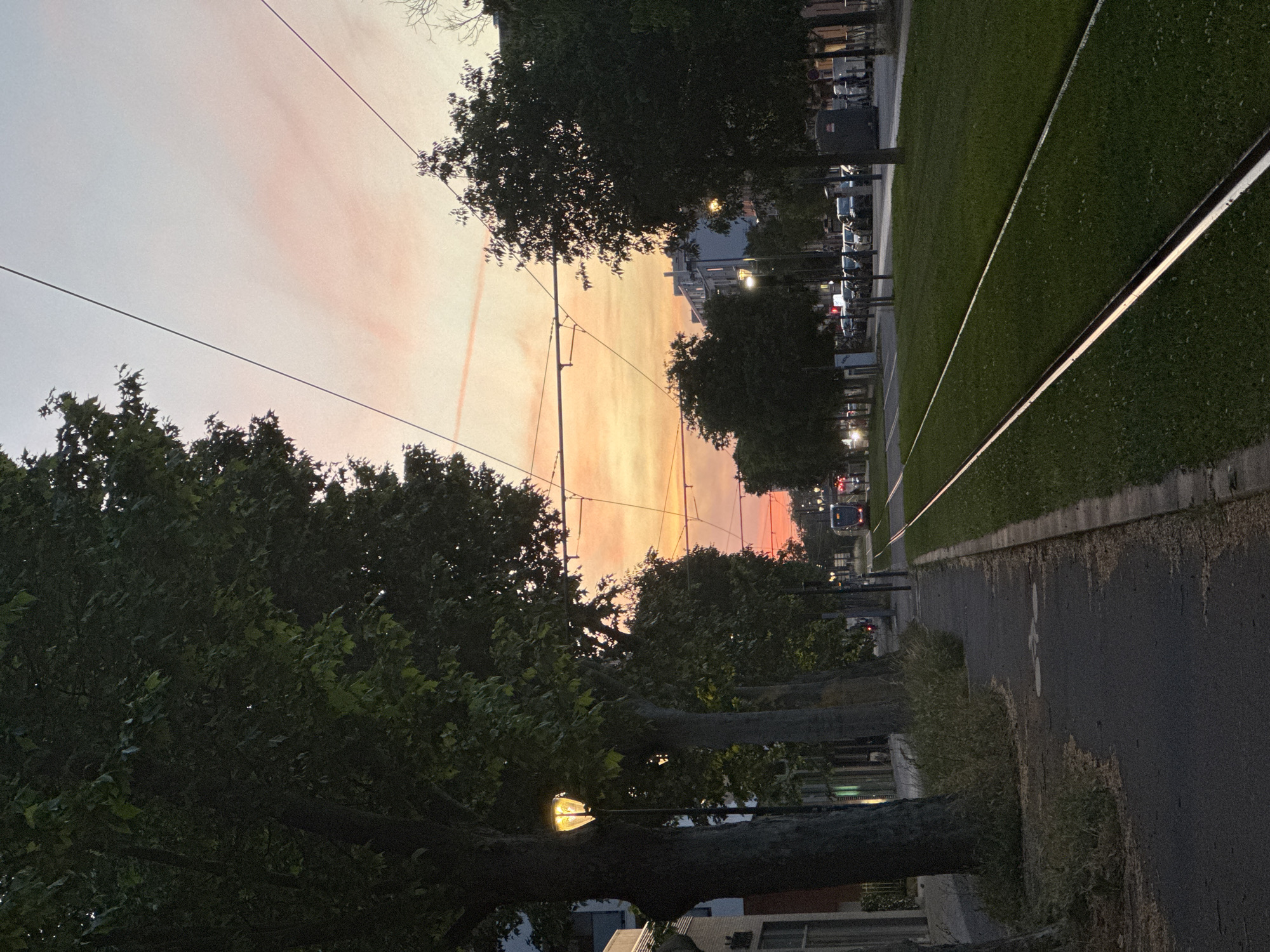 Evening tram operations documented in residential Toulouse at sunset