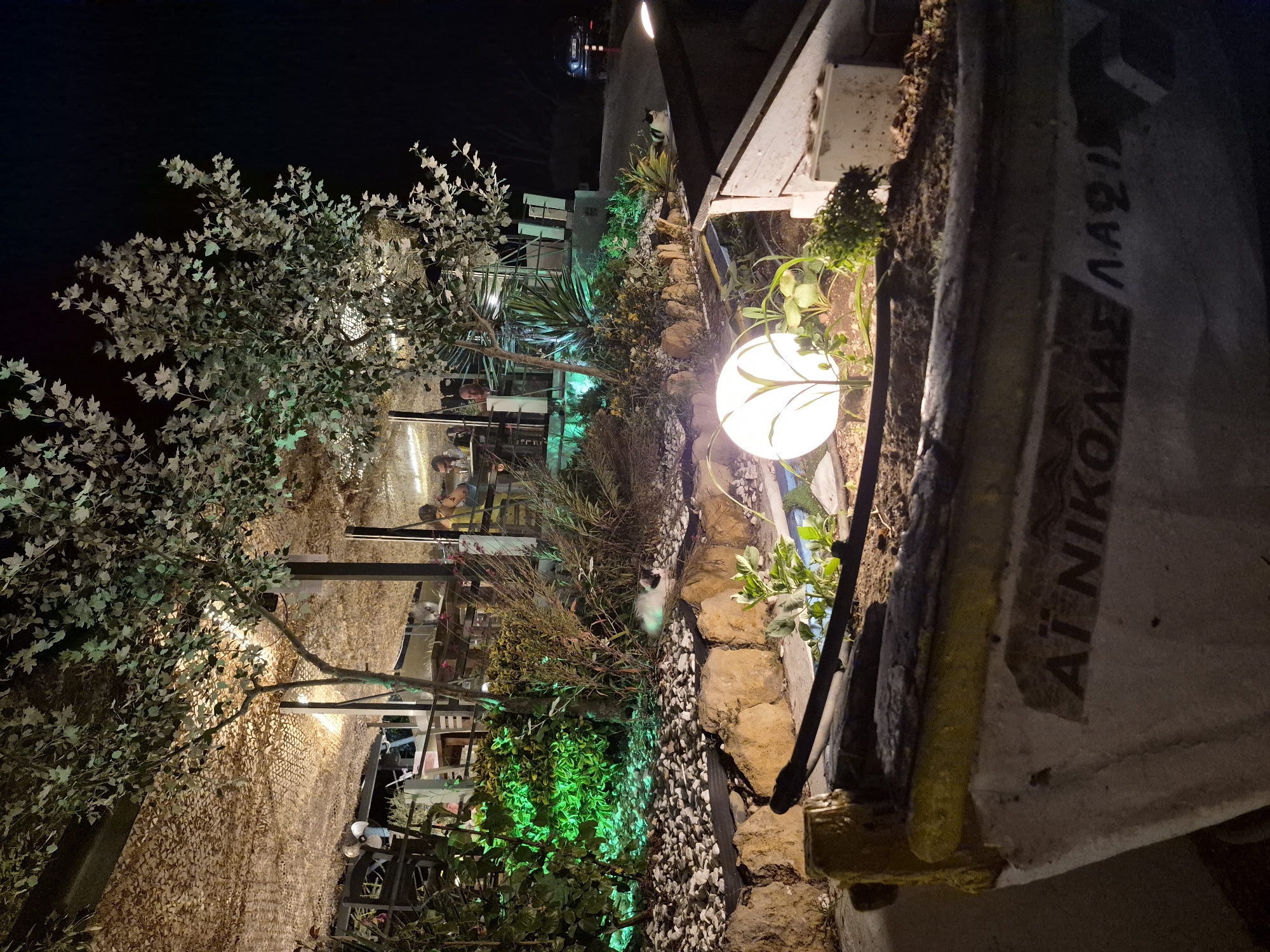 Seaside taverna night in Makri under a full orange moon