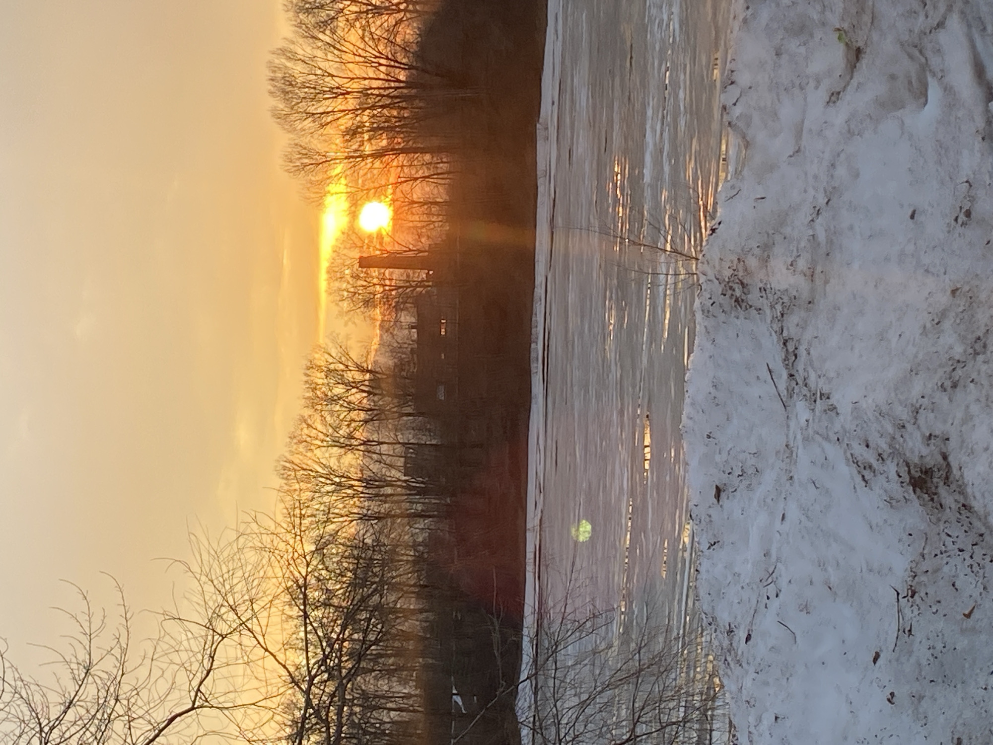 Winter sunset observed over frozen water in Chaikovsky, Russia