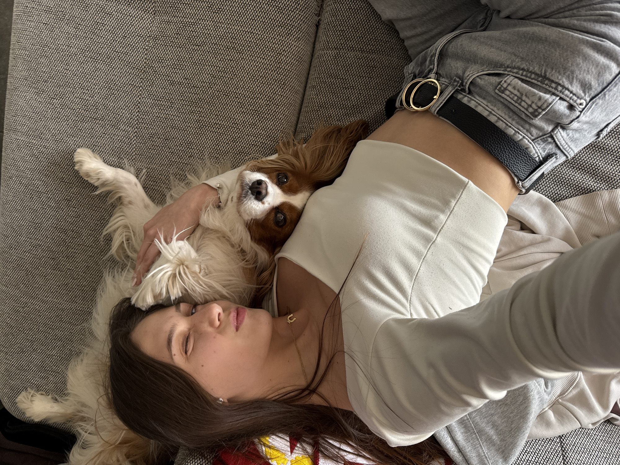 Woman takes mirror selfies, relaxes with spaniel in Sofia
