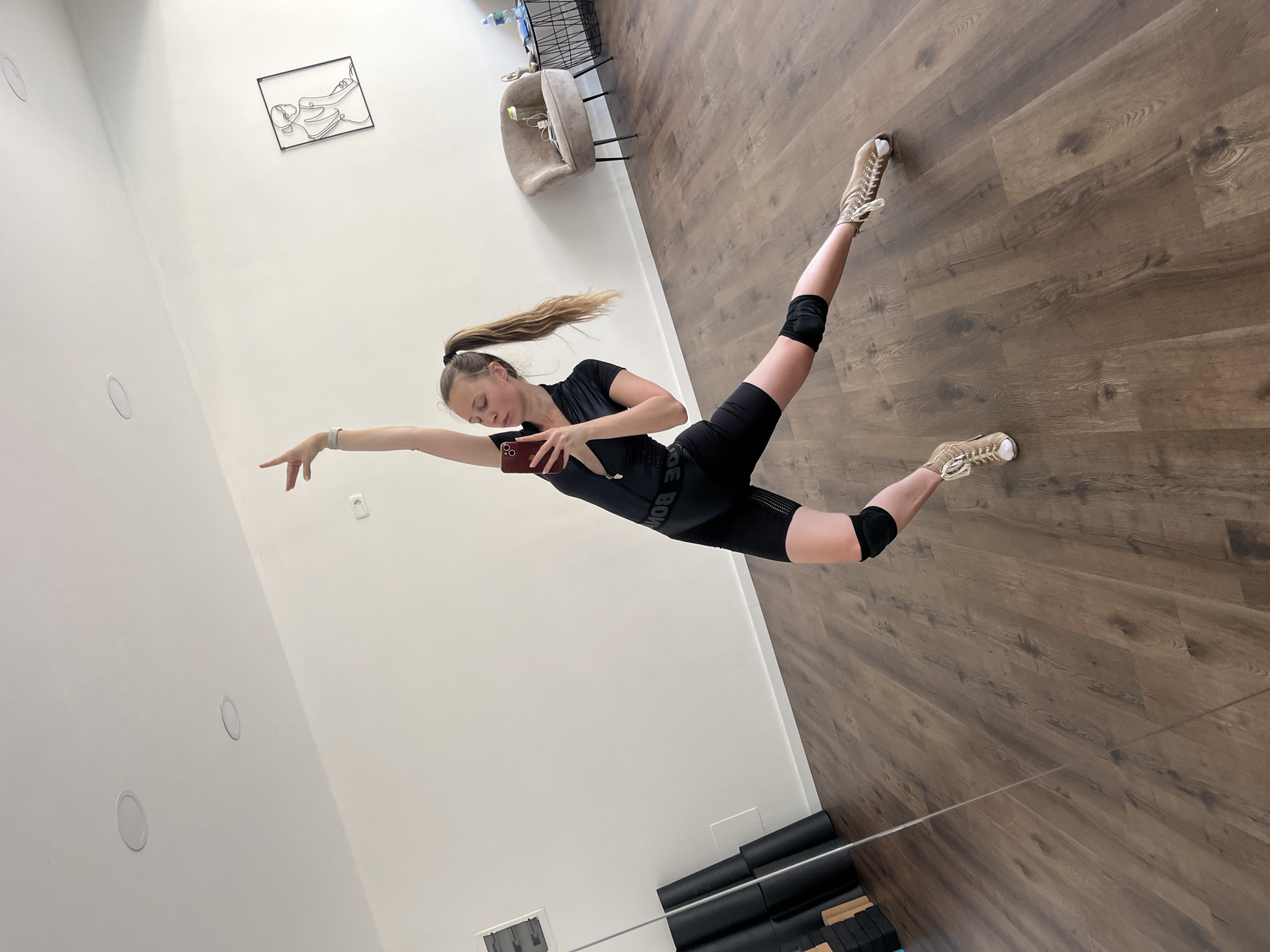 Woman photographed in dynamic poses during indoor photo session