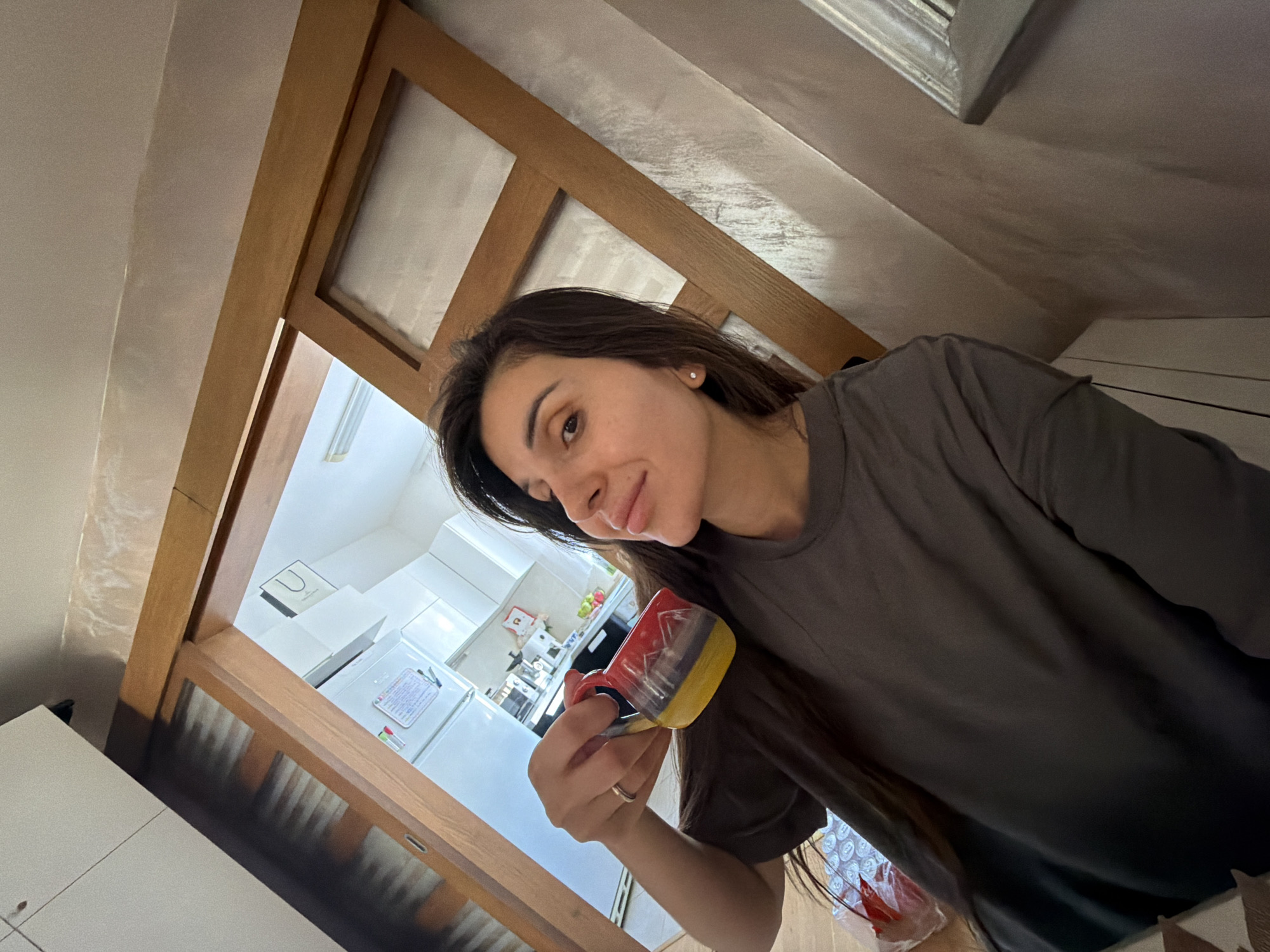 Woman holds colorful mug in Budva Montenegro kitchen