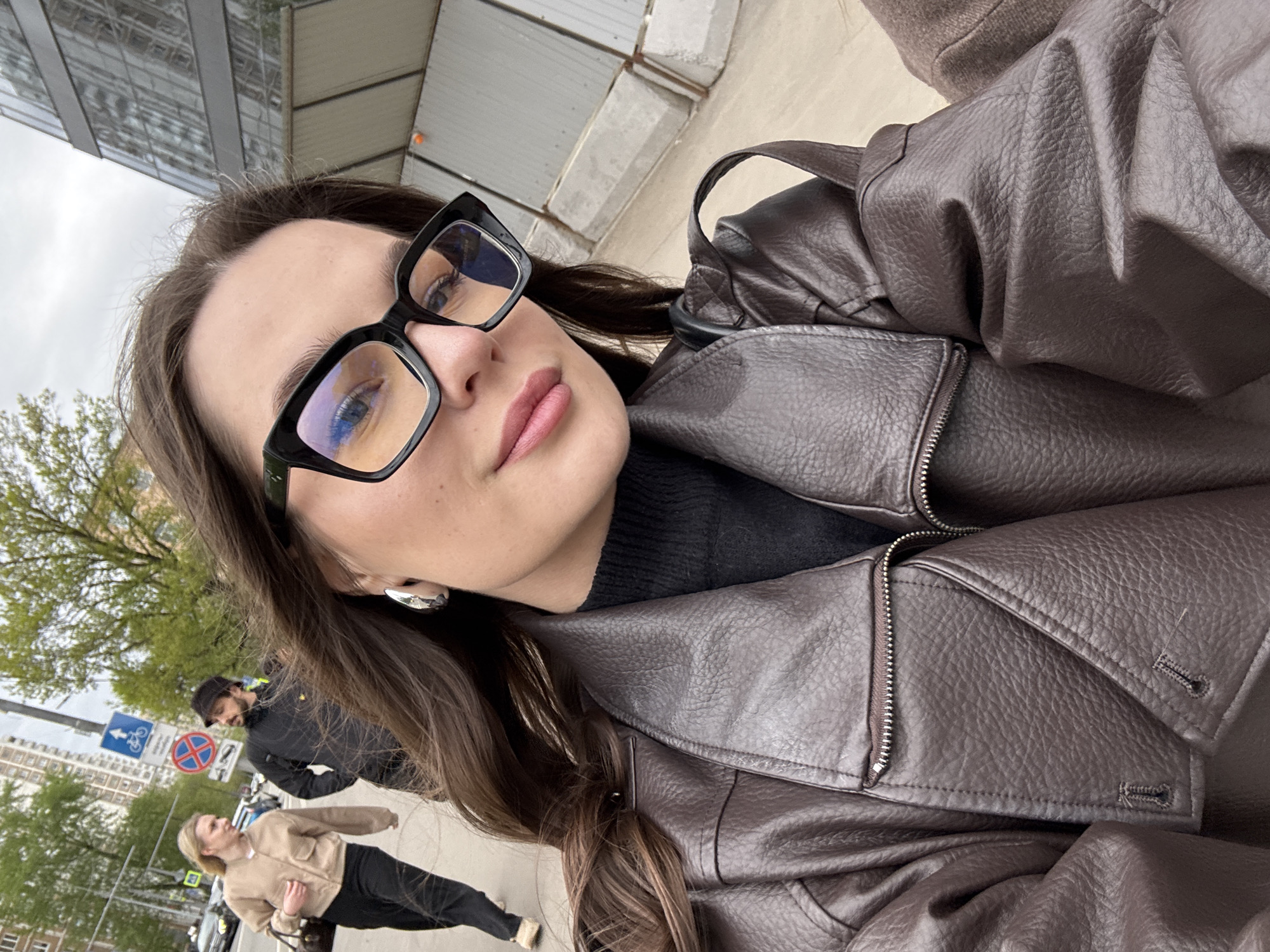 Woman takes selfie on Moscow sidewalk