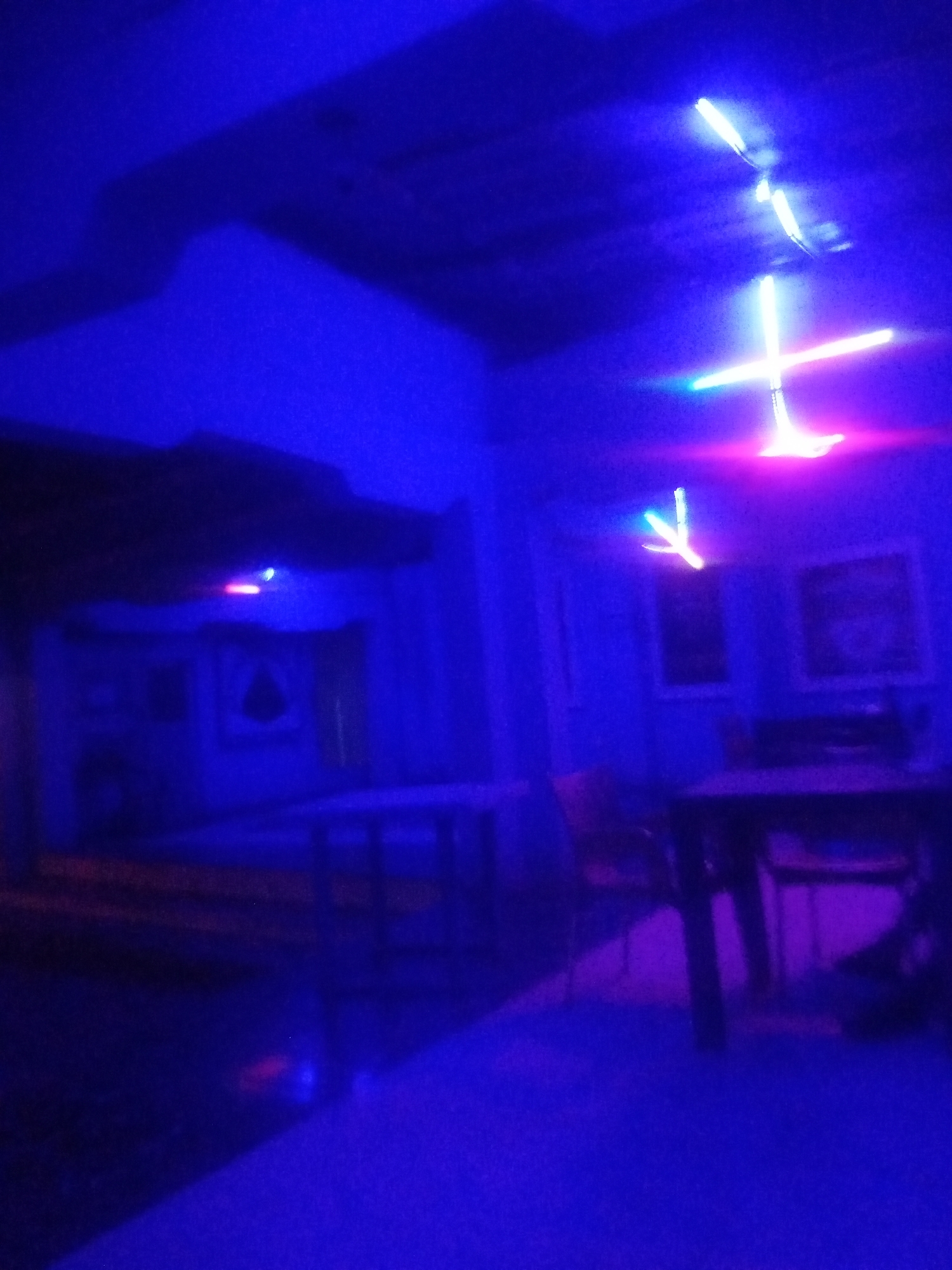 Neon-lit bar night with grilled fish in Sabon Gari, Nigeria