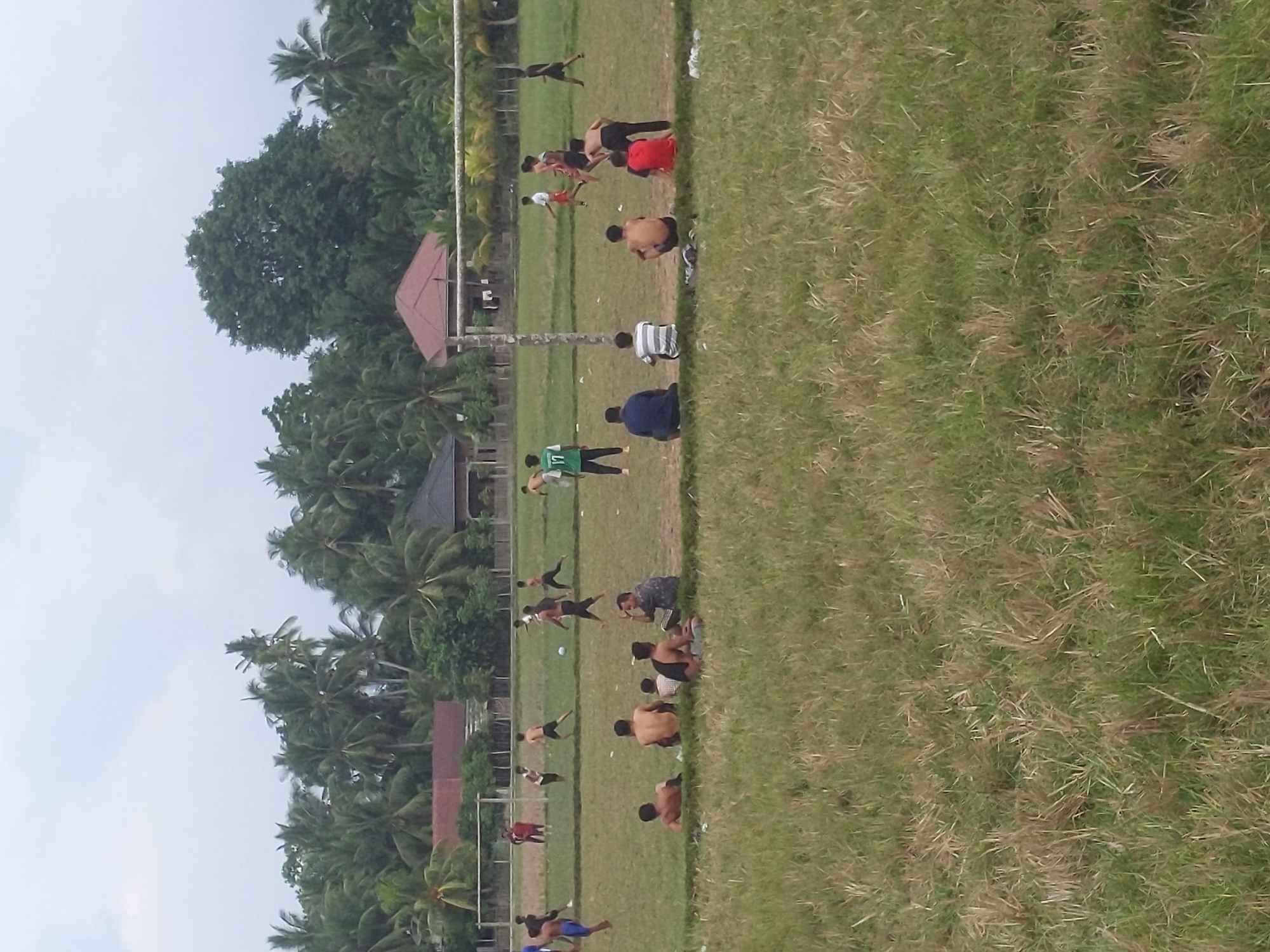 Group activity on a grassy sports field in Keutapang, Indonesia